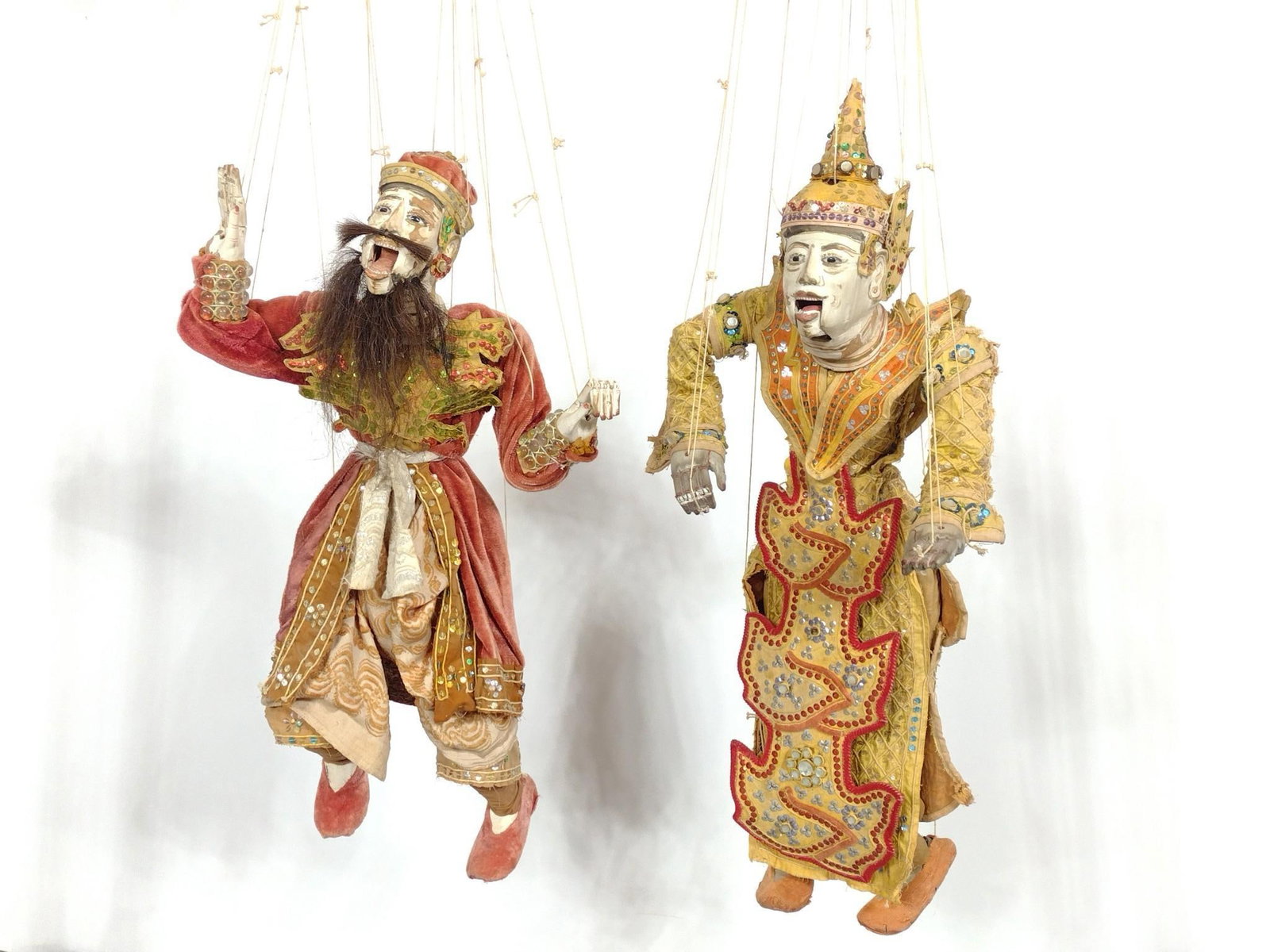 2 Asian String Puppets: 14" to 15" wide x 8" to 9-1/2" deep x 25" to 30" high (puppet only). Overall with strings: 50" to 52" high. Some wear consistent with age and use. PROVENANCE: From the Estate of James L. Stanfield, Ve