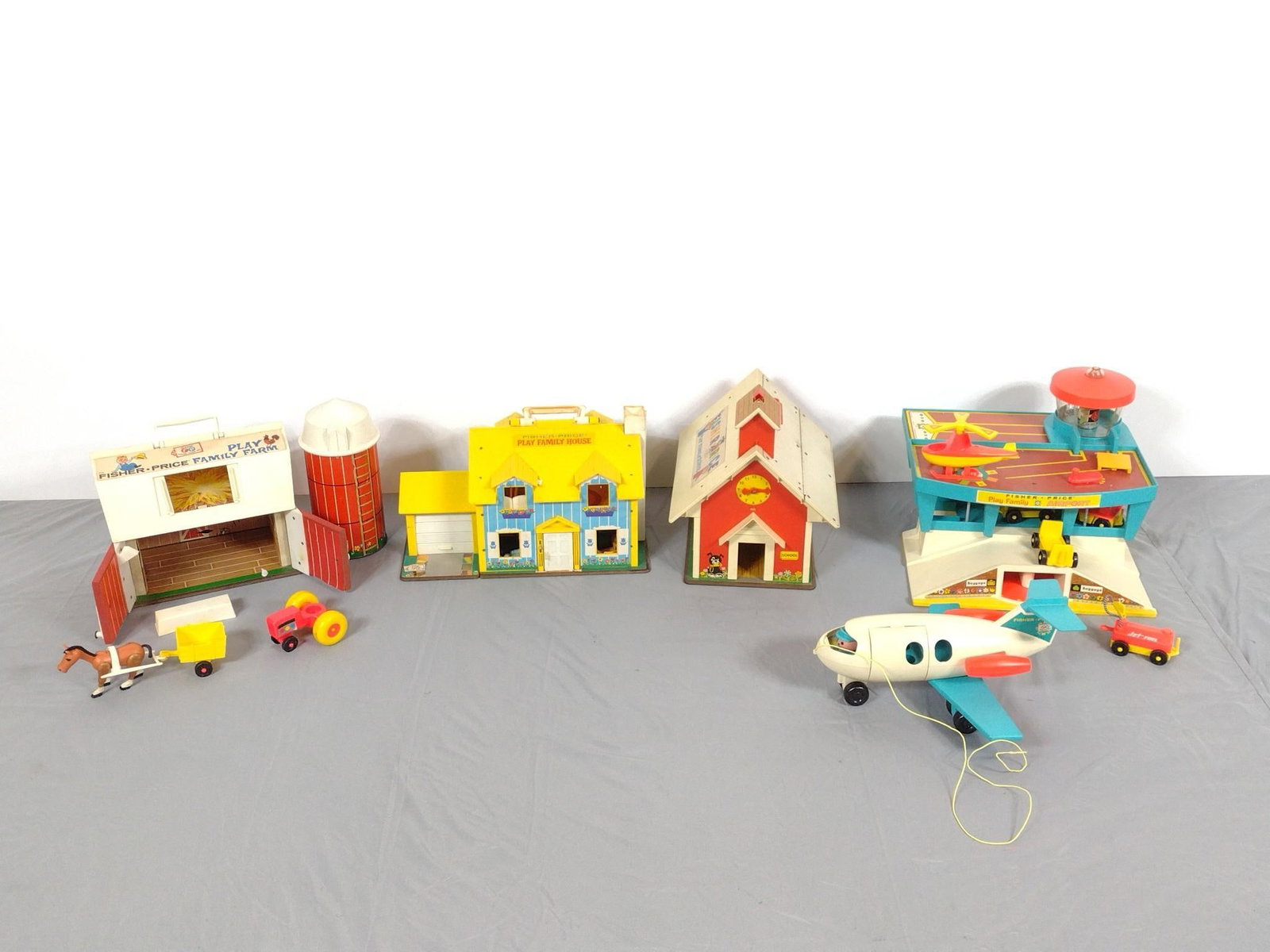 5 Fisher Price Toys: NOT ELIGIBLE FOR IN-HOUSE SHIPPING. Includes Barn, School, Airplane with Landing Strip and more. 6-1/4" to 12" high. All with some wear consistent with age and use.