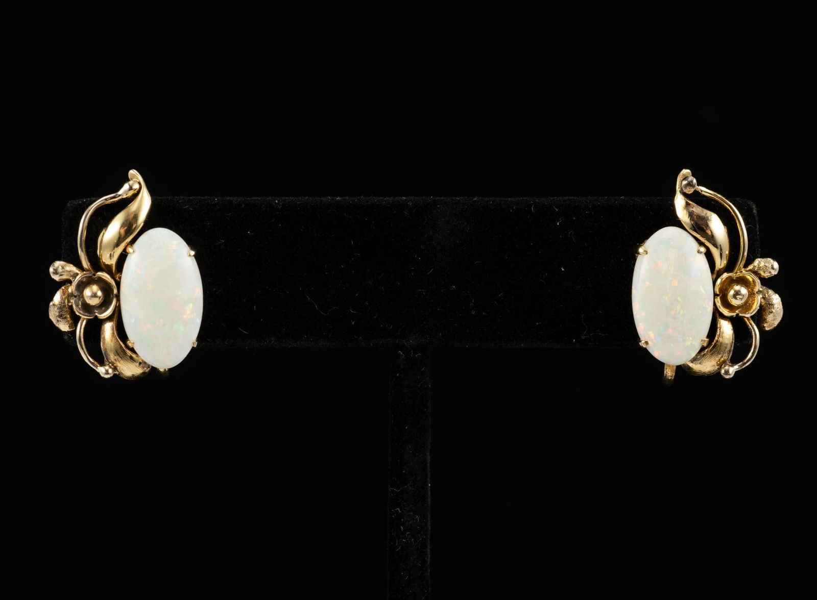 14K Gold and Opal Earrings: Screw-back earrings with a 14k gold floral pattern and opal stone measuring 3/4" across and with weight of 4.6 grams.