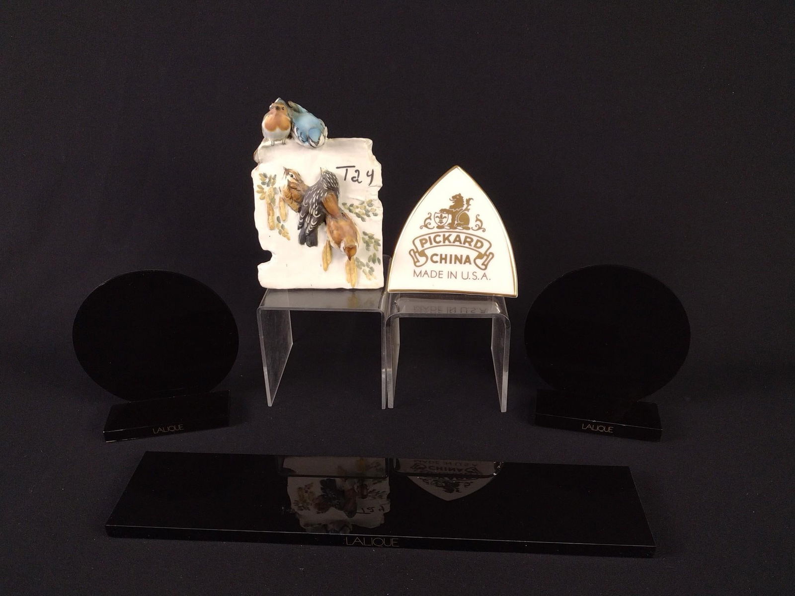 5 Lucite and Porcelain Plaques / Stands incl Lalique: 1/2" to 6-1/4" high. 3 black Lalique stands are lucite. Also includes Pickard and Tay Italian Porcelain Co plauqes.