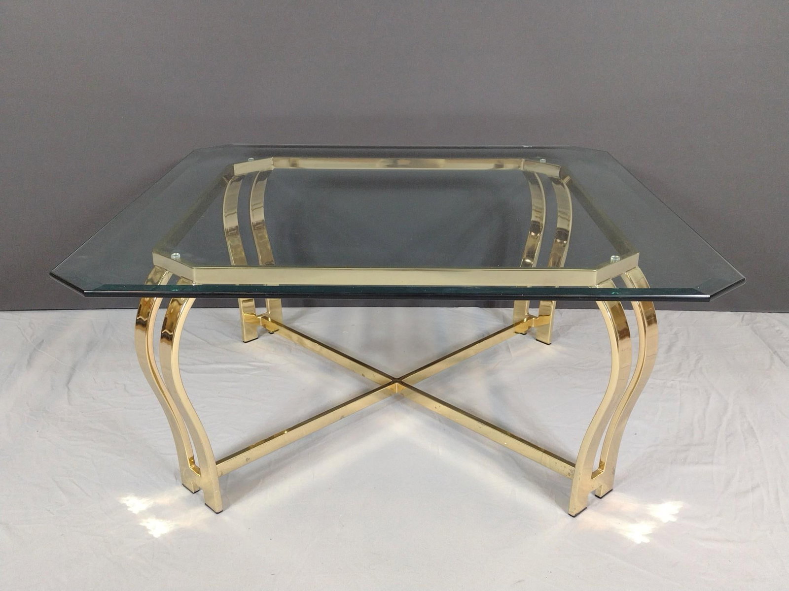 Brass & Glass Coffee Table: NOT ELIGIBLE FOR IN-HOUSE SHIPPING. 38" wide X 38" deep X 17-1/4" high. Metal base has areas of finish loss. No manufactures name found.