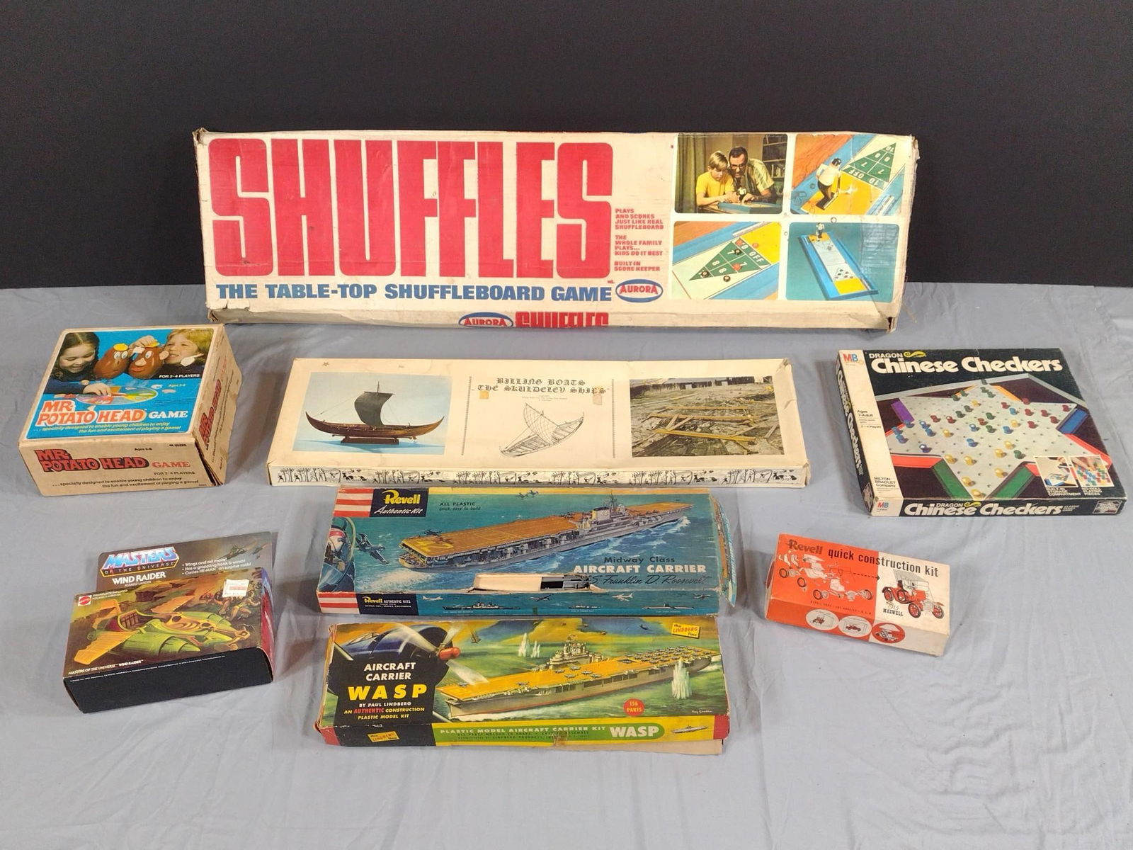 8 Vintage Games and Models: NOT ELIGIBLE FOR IN-HOUSE SHIPPING. Includes Shuffleboard, Revell Aircraft Carrier, Lindberg WASP Aircraft Carrier, Chinese Checkers, Mr. Potatoe Head, Masters of The Universe Wind Raider, 1913 Maxwel