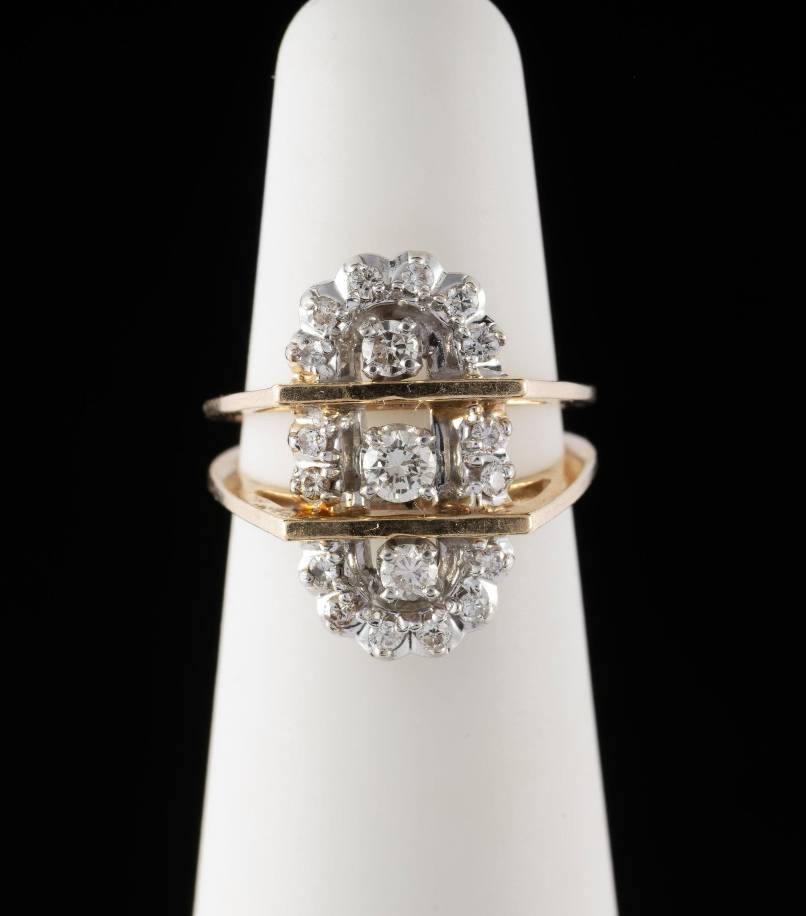 14K Yellow Gold & .59 CTW Diamond Ring: Marked 14k yellow gold shank and platinum top. Three central diamonds accented by 16 small diamonds. Center diamond approximately .15 carat, total diamond weight approximately 0.59 carat. Ring weight 
