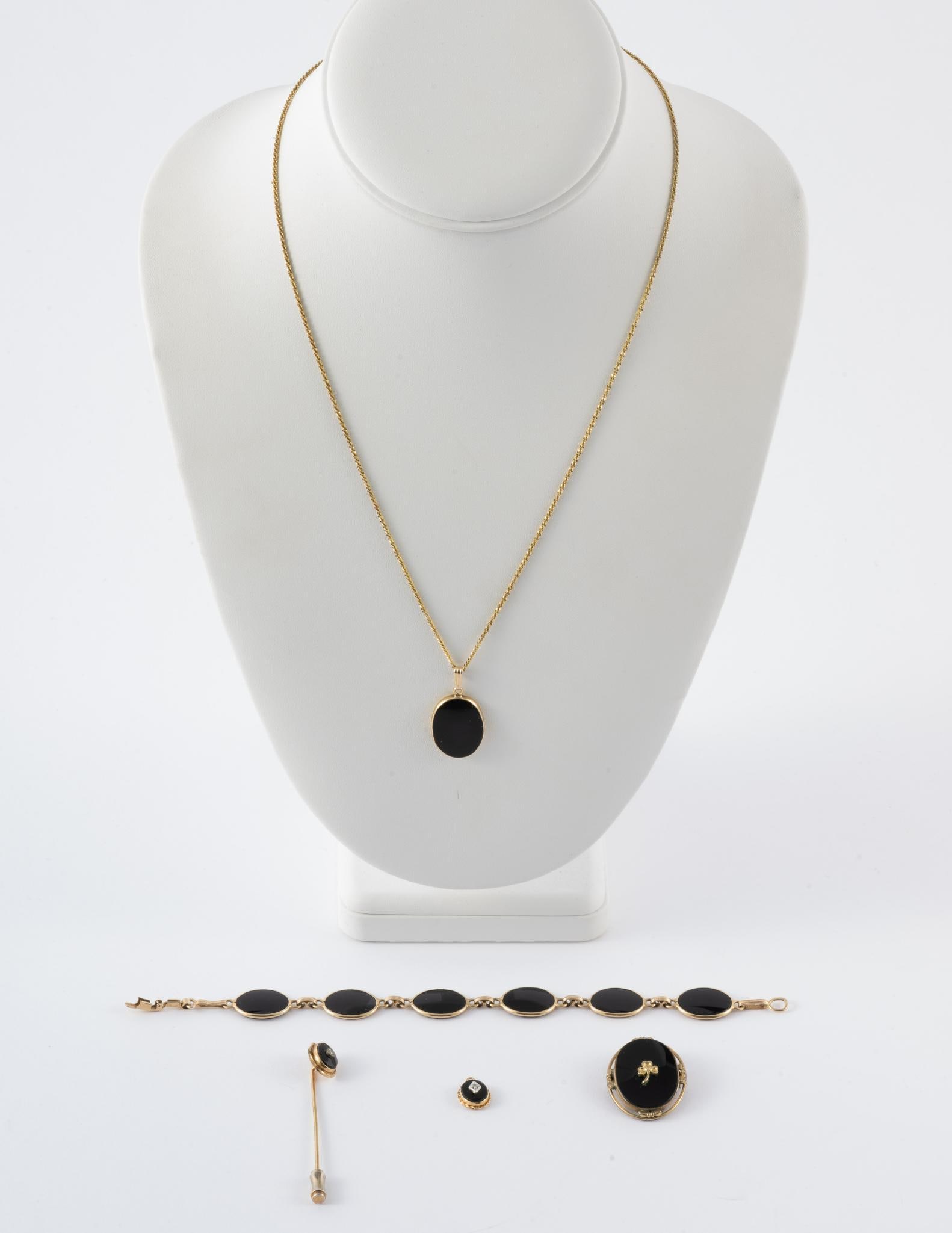 5 Pcs. 14K Yellow Gold & Onyx Jewelry: A variety of onyx and yellow gold jewelry. The pin and the brooch with central clover are gold filled. The 14k gold chain and 14k gold bracelet have a gold weight of 8.4 grams not including the onyx s