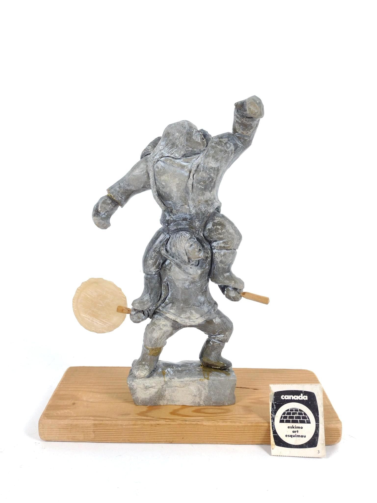 Bobby Anavilok "Drum Dancers" Sculpture: Sculpture only: 6-1/2" wide x 1-1/2" deep x 9-1/4" high. Repairs at ankles and feet. Wood base: 9-1/2" wide x 3-1/2" deep.