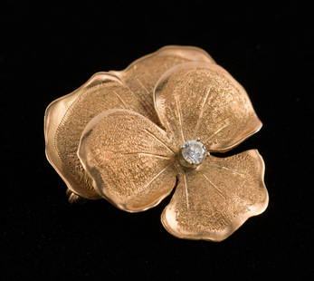 14K Gold & Diamond Pansy Pin: DESCRIPTION: Marked 14k gold pansy pin set with approximately .10 carat round brilliant cut diamond. MEASUREMENTS: 5.2 grams. 1-1/4" wide. CONDITION: Very light wear.