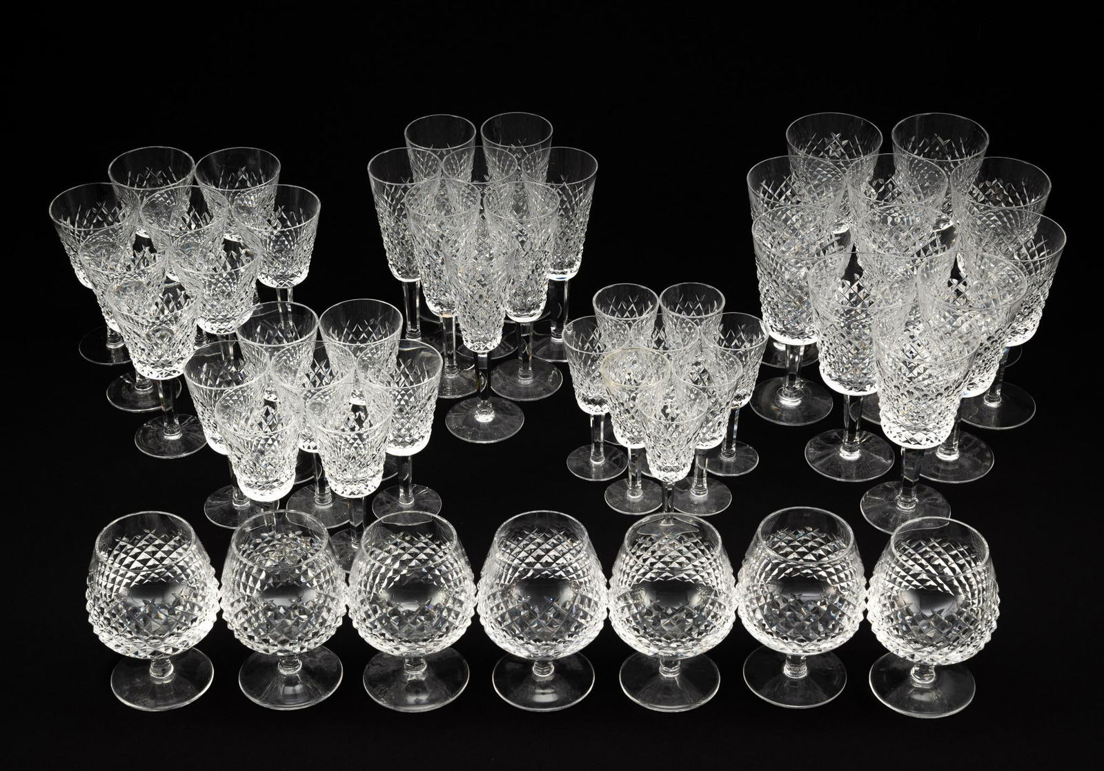 49 Pcs Waterford Alana Stemware: DESCRIPTION: Includes (7) brandy glasses 4" diameter x 5" high; (11) water goblets 3-1/2" diameter x 7" high; (8) claret wine flutes 3-1/8" diameter x 5-7/8" high; (7) white wine flutes 3-3/4" diamete