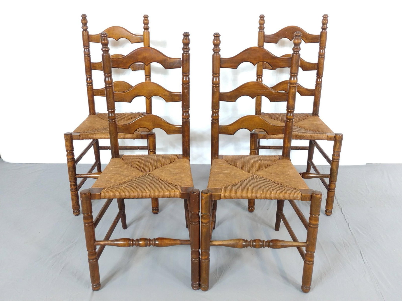 4 Rush Seat Ladder Back Chairs: NOT ELIGIBLE FOR IN-HOUSE SHIPPING. Each 18" wide X 16" deep X 38-1/2" high. All have some light scratches.
