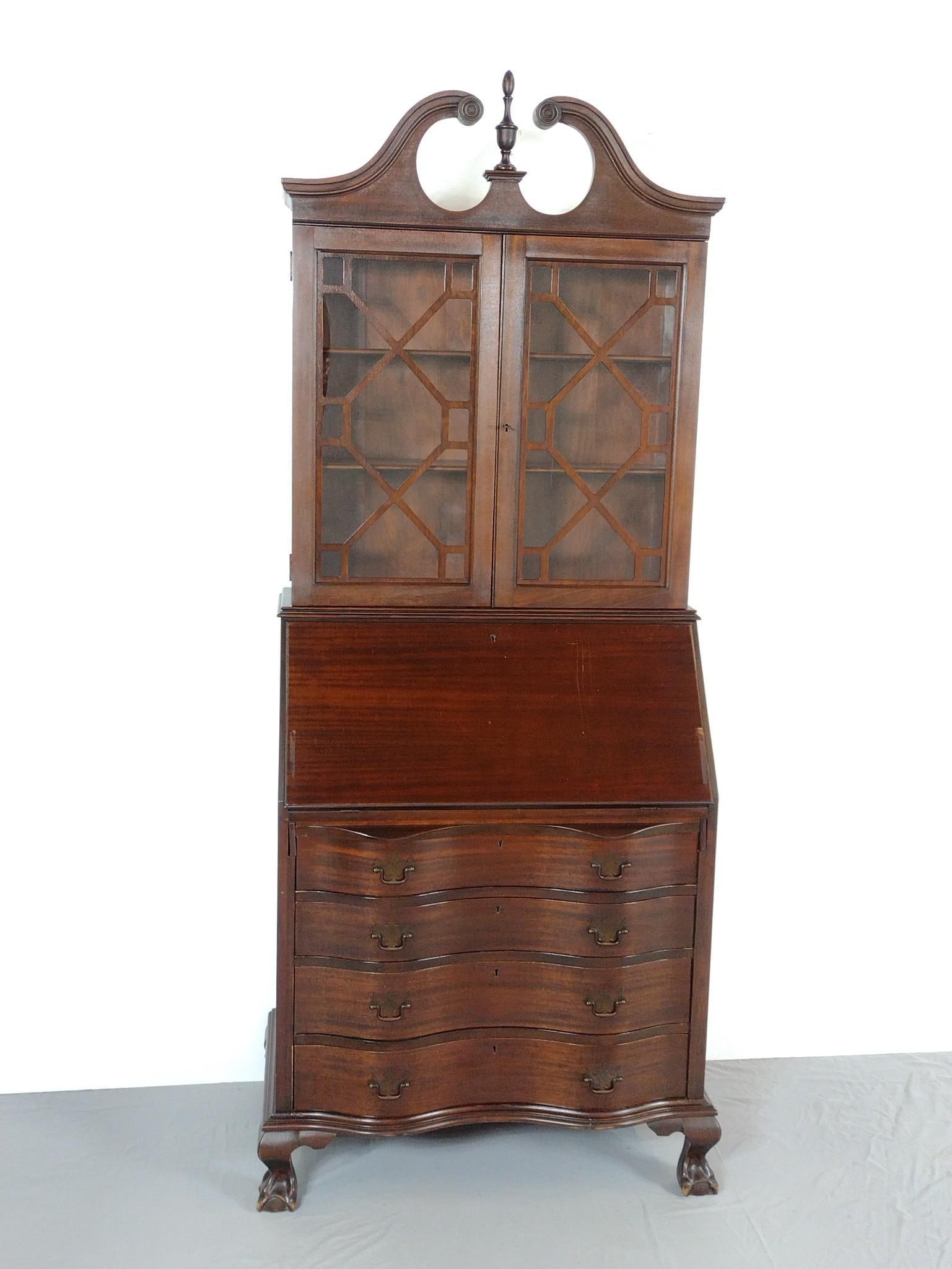 Secretary Desk Bookcase: NOT ELIGIBLE FOR IN-HOUSE SHIPPING. Serpentine front base with ball and claw feet. 33" wide X 19" deep X 78" high. Has some scratches. No manufactures name found.