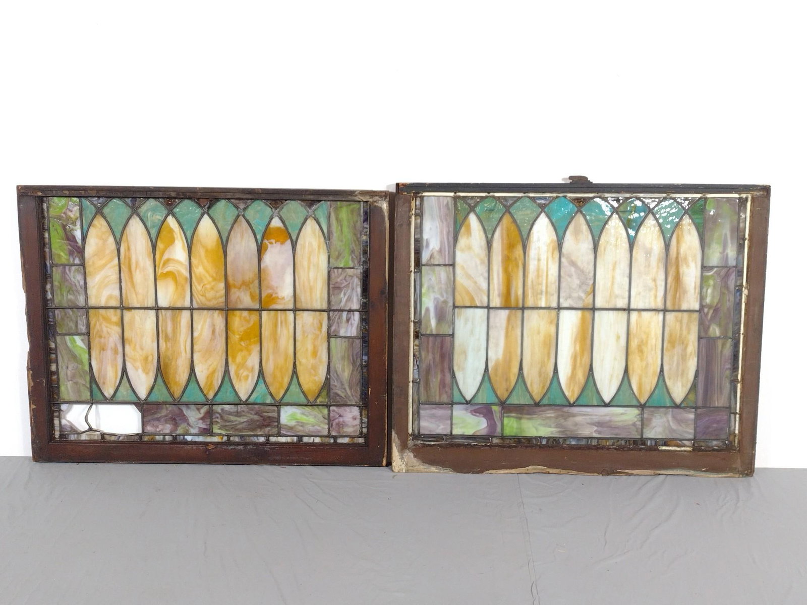 2 Stained Glass Windows: NOT ELIGIBLE FOR IN-HOUSE SHIPPING. 44" wide X 34" to 35-1/2" high. One has broken glass panels. Both have damage to frames.