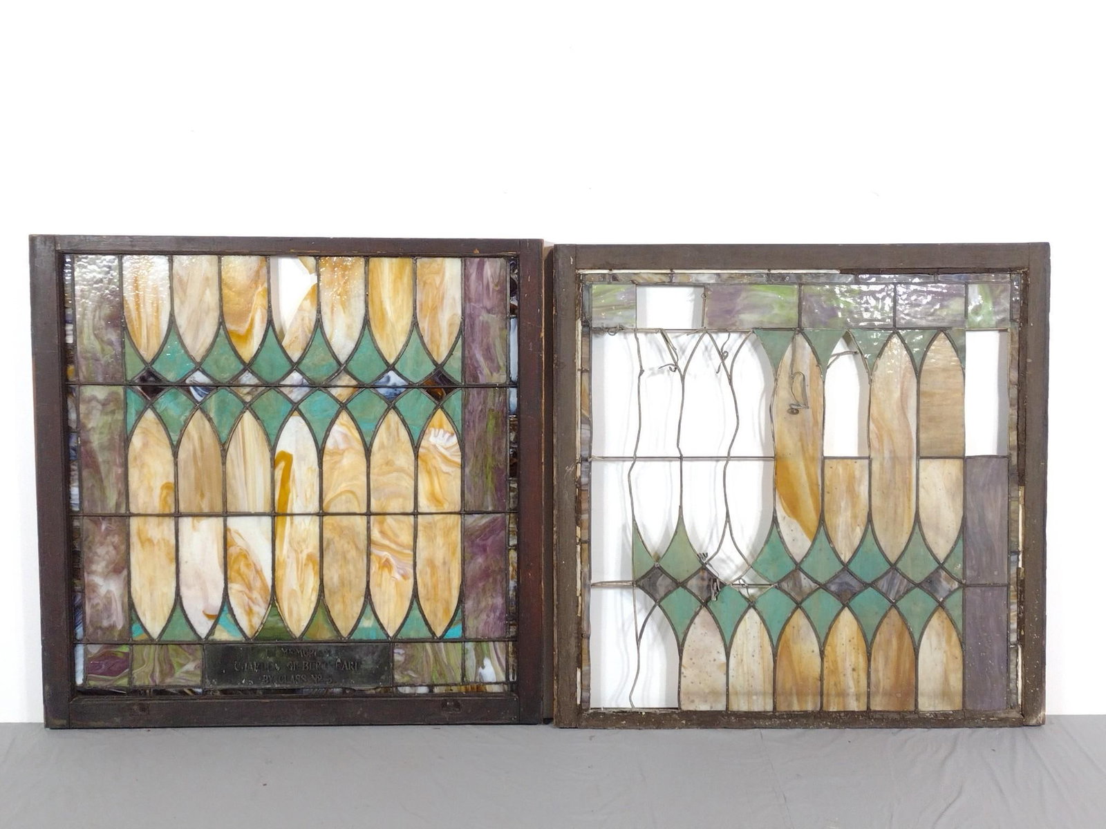 2 Stained Glass Windows: NOT ELIGIBLE FOR IN-HOUSE SHIPPING. 44" wide X 34" to 35-1/2" high. One has broken panel, the other is missing many panels. Both have damage to frames.