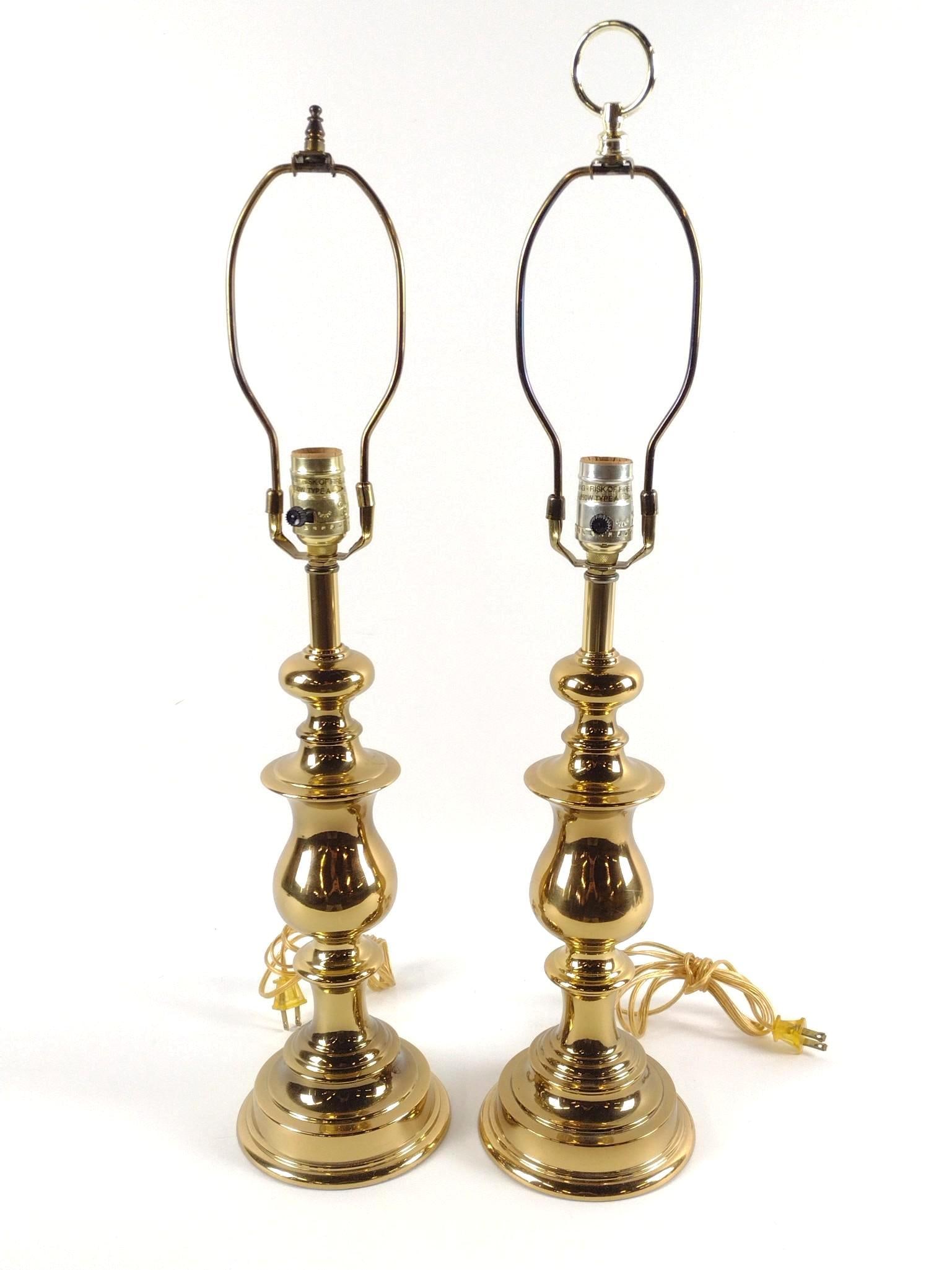Pr Brass Table Lamps: NOT ELIGIBLE FOR IN-HOUSE SHIPPING. Unmarked. Working. Overall with harps: 5-3/4" diameter x 26" to 27-1/2" high.