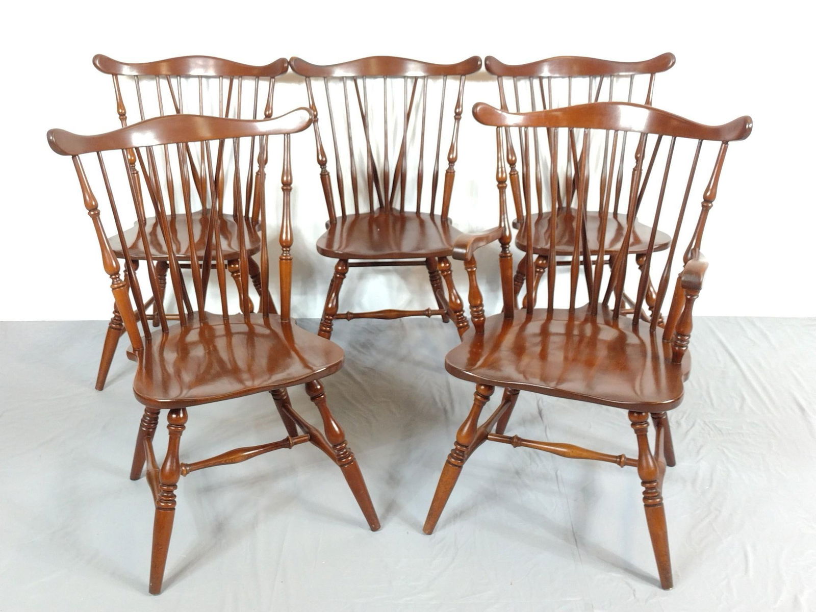 5 Windsor Chairs: NOT ELIGIBLE FOR IN-HOUSE SHIPPING. Includes 4 side chairs and 1 arm chair. Each 18" wide X 22" deep X 34" high. Chairs have light scratches. No manufactures name found.