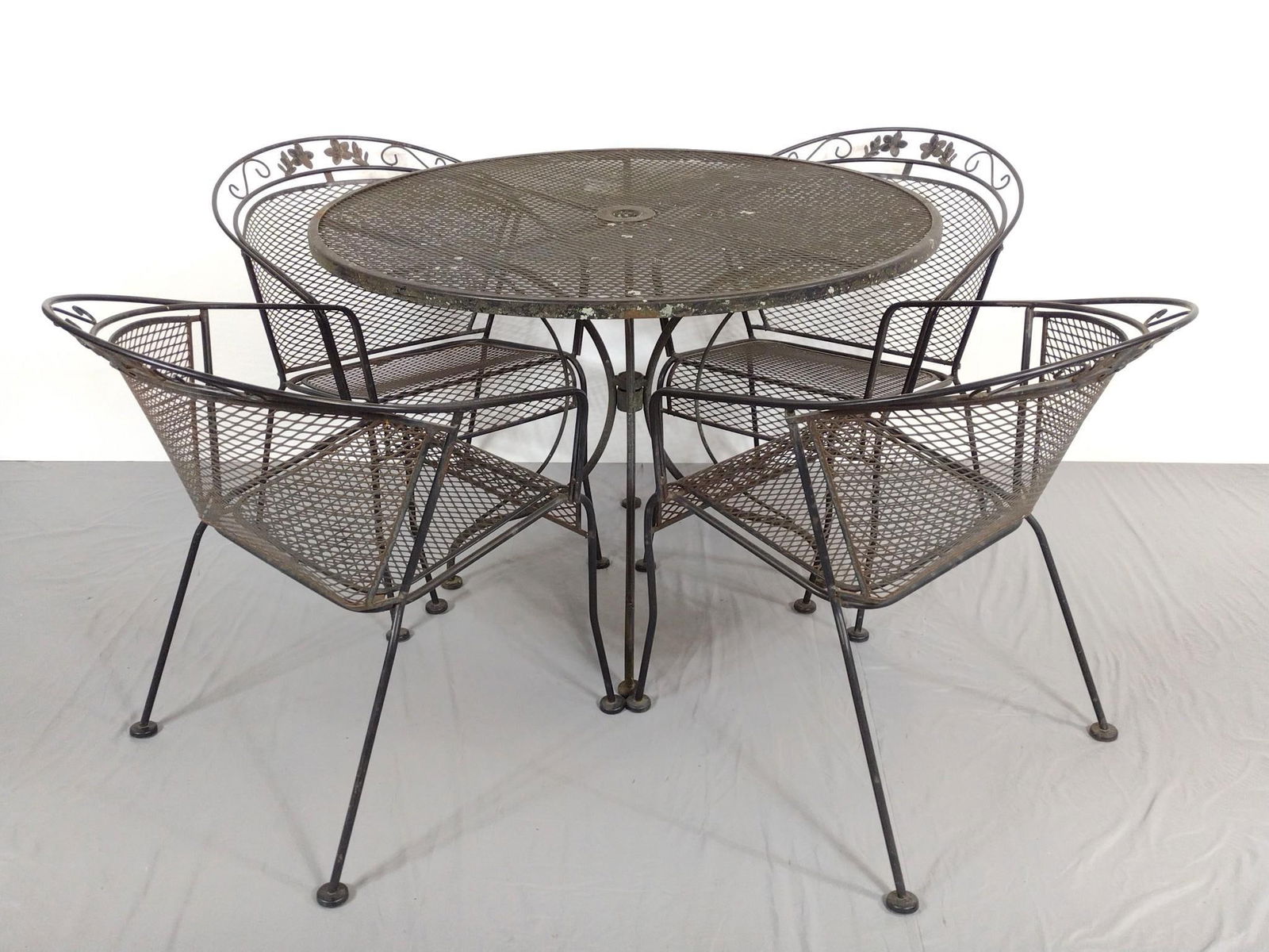 Metal Outdoor Table and 4 Chairs: NOT ELIGIBLE FOR IN-HOUSE SHIPPING. Table 42" diameter X 29-1/2" high. Chairs 24" wide X 24" deep X 30-1/2" high. All have some discoloring and rust.