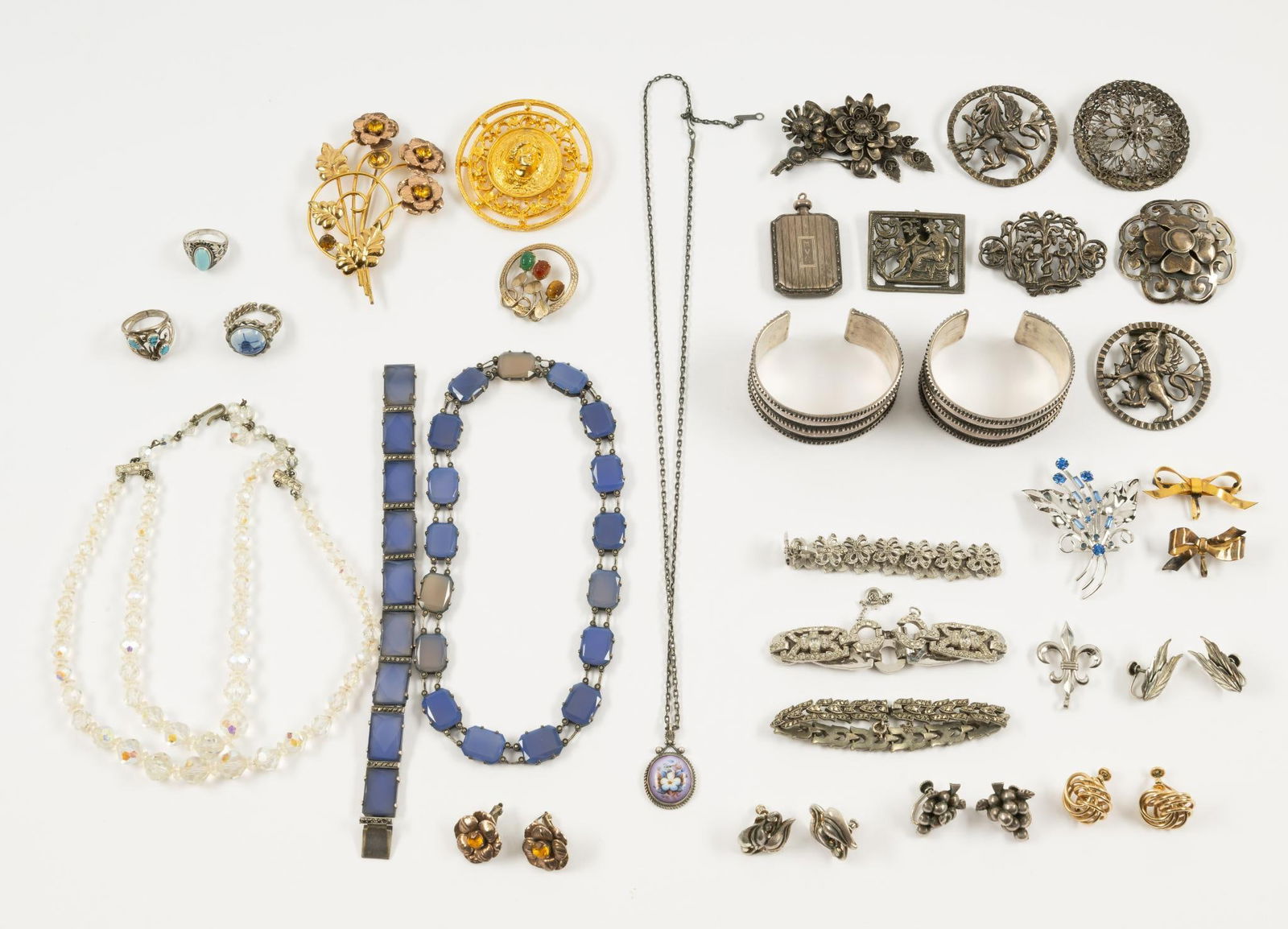 Large Lot of Costume and Sterling Silver Jewelry: Everything from cuff bracelets to an antique sterling perfume bottle. Plenty of antiques including at least 6 troy ounces sterling silver. This lot includes a sterling and blue chalcedony choker neckl