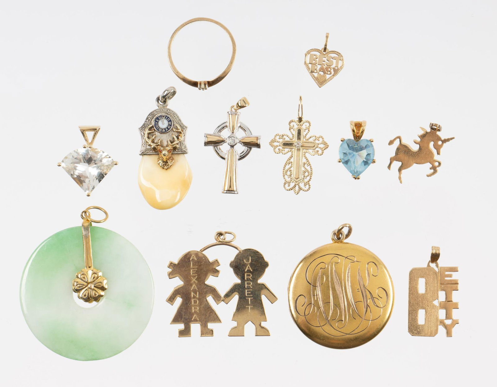 14K Gold Pendant Lot: Various 14k gold pendants including an Elks Lodge gold and elk tooth pendant, two gemstone pendants, a milky green jade wheel pendant, a monogrammed locket, a Betty pendant, and others. Total weight o