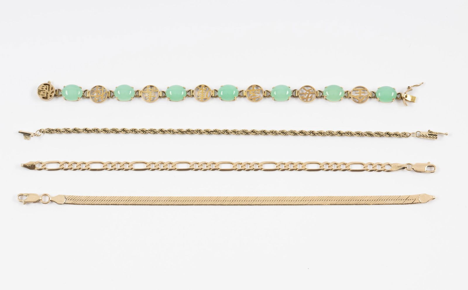 4 14K Gold Bracelets: Includes Asian link with green chalcedony cabochons, and three chain bracelets. All marked 14k. 7" to 7-1/4" long. 25.9 grams.
