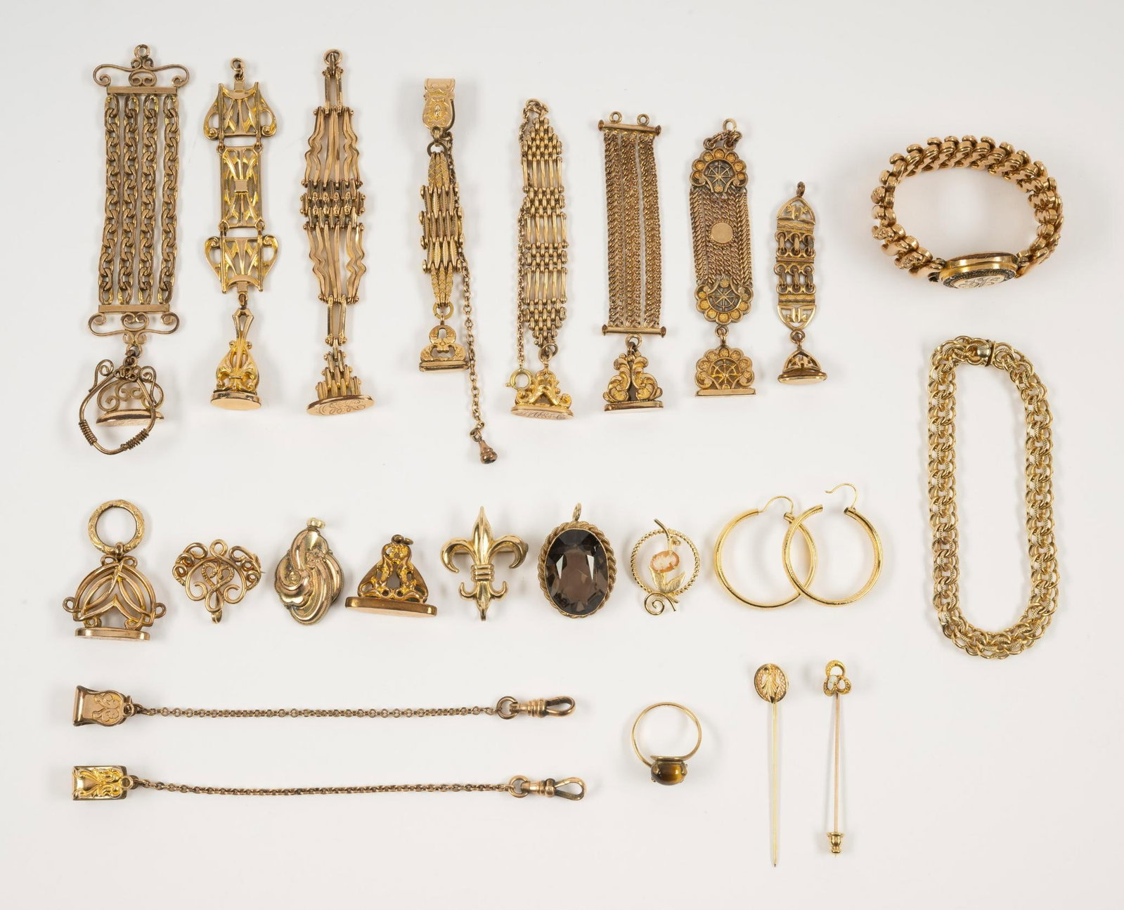 Grouping of Gold-Filled Jewelry: Includes pins, bracelets, pendant, earrings, stick pins, watch fobs, and ring. 1" to 7-1/2". Ring size 7-1/2.