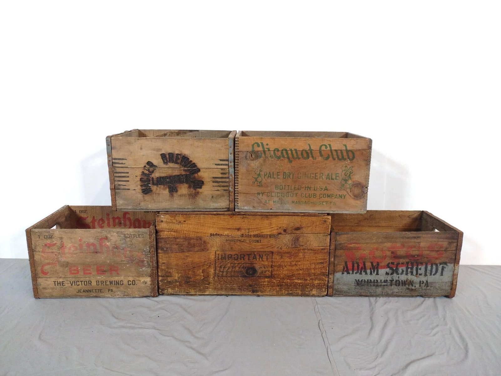 5 Advertising Crates Incl Adam Scheidt: NOT ELIGIBLE FOR IN-HOUSE SHIPPING. Also includes Clicquit Club, Beech-Nut, Wacker Brewing and Steinhaus Beer. 17" to 24-1/2" wide X 12" deep X 10" to 13" high. All have some wear.