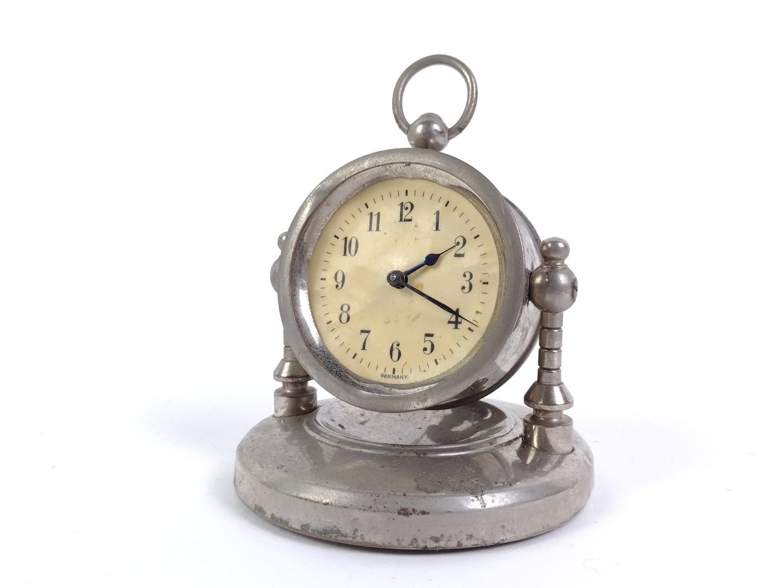 German Desk Clock: Not working. 3-1/4" diameter x 4" high (adjustable based on the angle of the clock). Some wear and discoloration.