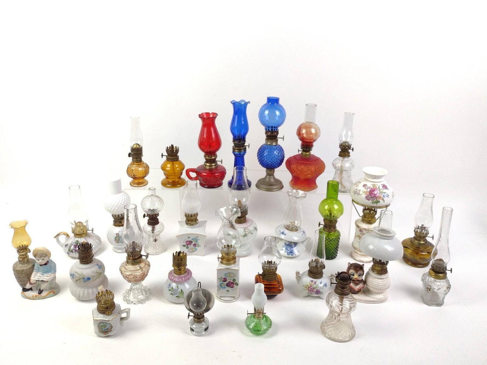 Miniature Oil Lamp Collection: Approximately 30 miniature oil lamps included. 4" to 9-3/4" high. Some wear consistent with age and use. One chimney with crack.