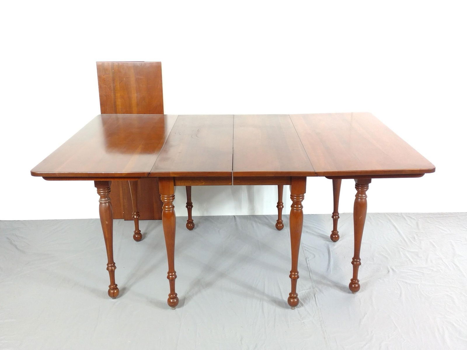 Drop Leaf Table: NOT ELIGIBLE FOR IN-HOUSE SHIPPING. Includes two leaves. Table closed 28-1/2", open 67" wide X 42" deep X 29-1/2" high. Leaves 12" wide each. Top has some finish loss.