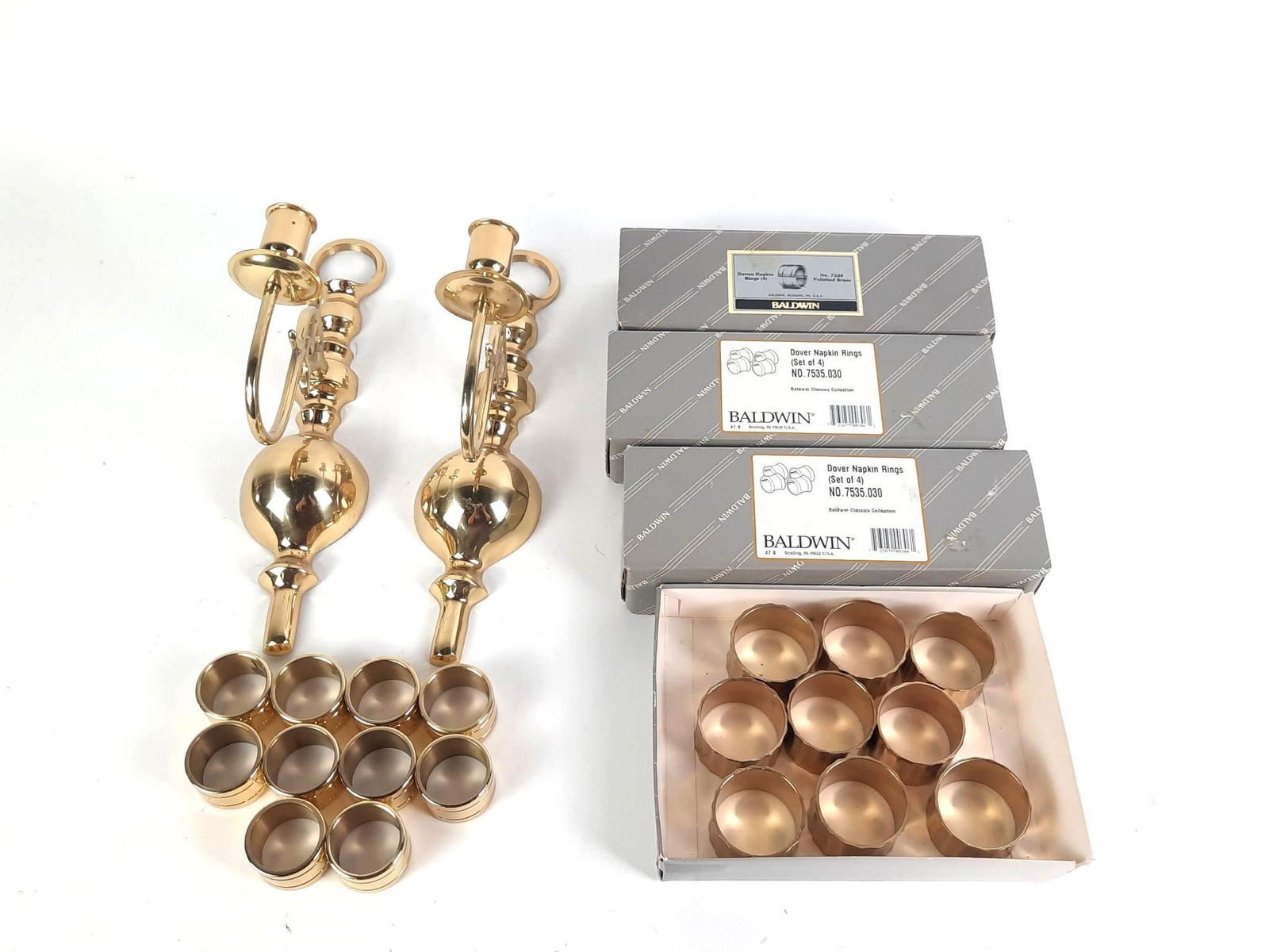 Large Grouping Brass incl Baldwin: Includes napkin rings and pair wall sconce candle holders. 3 sets of Baldwin napkin rings in original boxes (4 per box).
