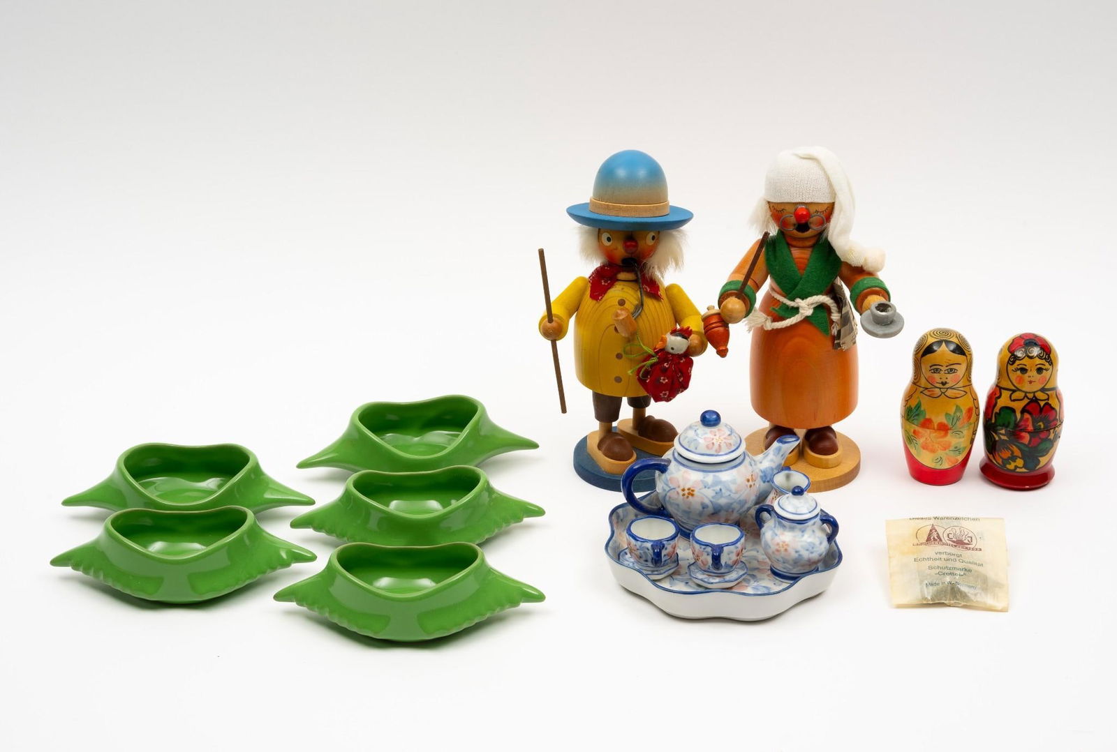 17 Pcs incl Smokers, Nesting Dolls and Ceramics: Includes 5 Hall mid-century dishes, miniature tea set, 2 smokers, and 2 sets of nesting dolls. 1/4" to 8-1/4" high.