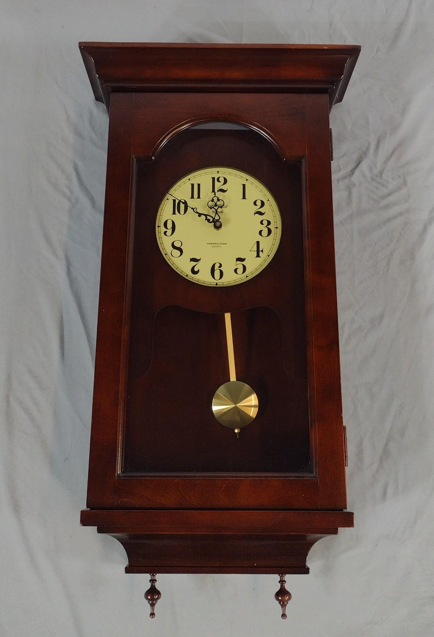 Hamilton Wall Clock: NOT ELIGIBLE FOR IN-HOUSE SHIPPING. Working. 16-1/2" wide x 6-3/4" deep x 31" high. Some minor scratches to finish.