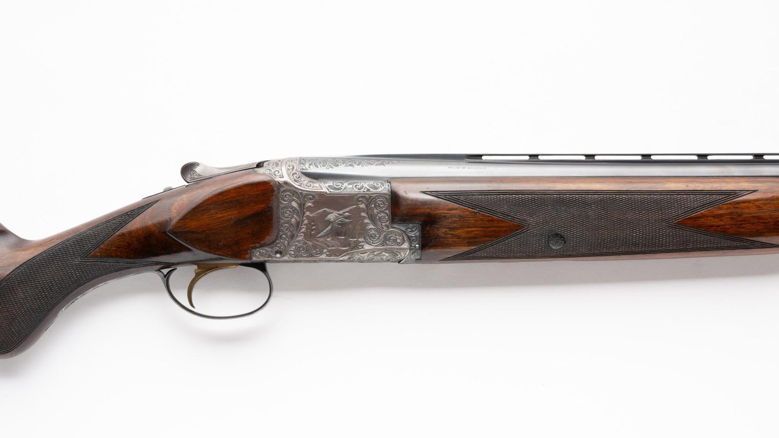 Engraved Belgian Browning Over/Under Shotgun, 12 Gauge: Serial Number: 68258 Design: Here is a classic engraved Belgian Browning superposed shotgun chambered for 2 3/4" 12 gauge shells. Factory records indicate that this over/under gun was made in 1958. Th