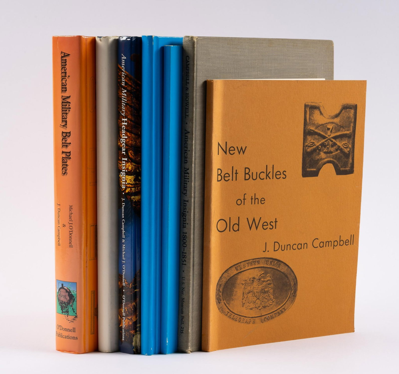 7 Military Books incl. Autographs: Five autographed books. All autographed by J. Duncan Campell. Autographed books include American Military Headgear Insignia; (2) Aviation Badges and Insignia of U.S. Army 1913-1946; American Military 