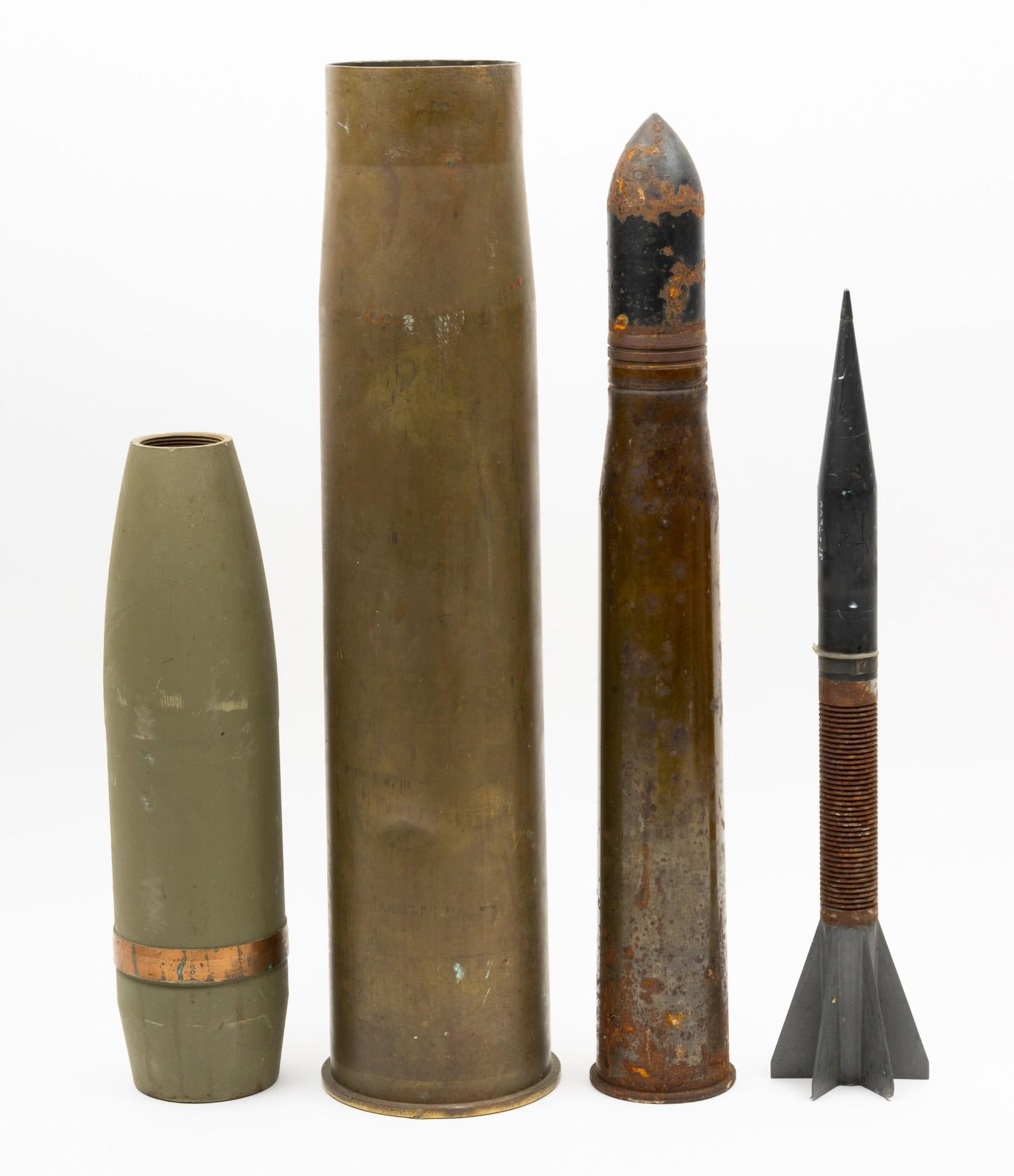 4 Artillery Shells: Includes U.S. M735 tank penetrator dart 105mm; U.S. 57mm M22 drill shell complete case; U.S. 105mm H.E. projectile (1945); and U.S. 105mm M115 electric primer (1962). 15-3/4" to 24-1/4" long.