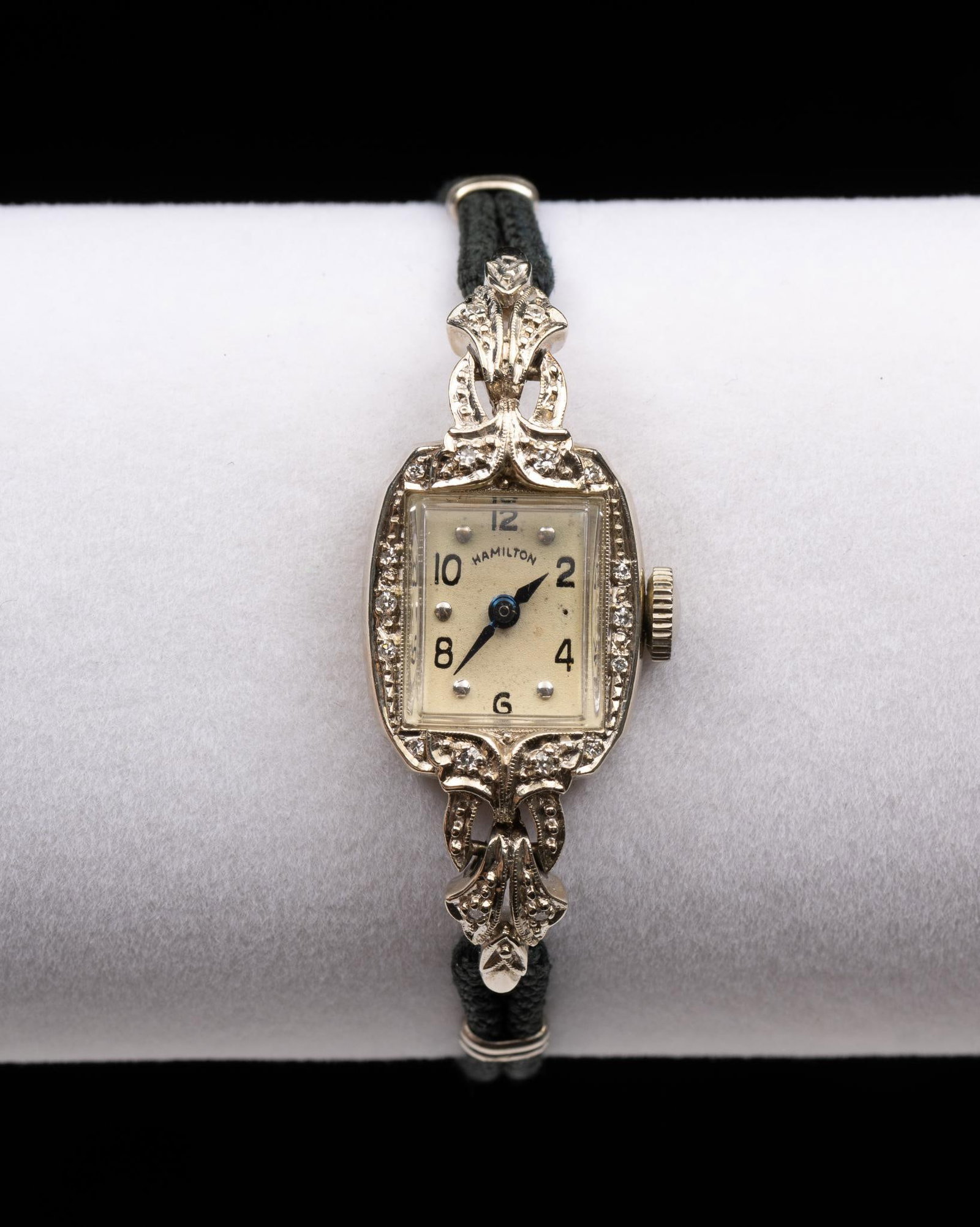 14K White Gold Hamilton Woman's Cord Watch: A mid-century Hamilton in white gold with small diamond accents. The watch runs and keeps time but not tested for accuracy. 6" length. Case and band weight 8.2 grams (not including works or crystal).
