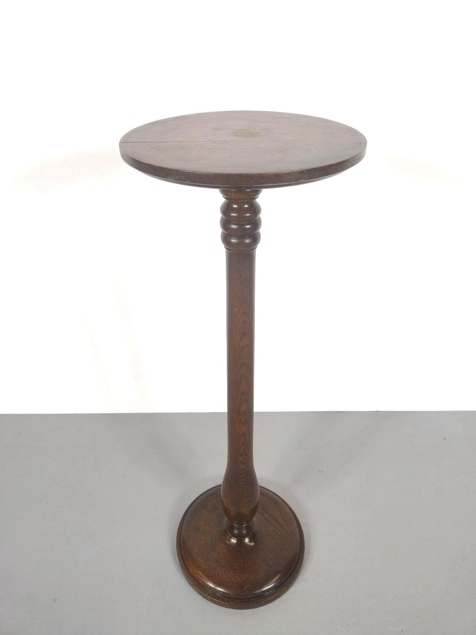 Wood Plant Stand: NOT ELIGIBLE FOR IN-HOUSE SHIPPING. 12-1/4" diameter X 36-1/2" high. Top has some light scratches and finish loss. Top starting to split. Base has a few scratches.