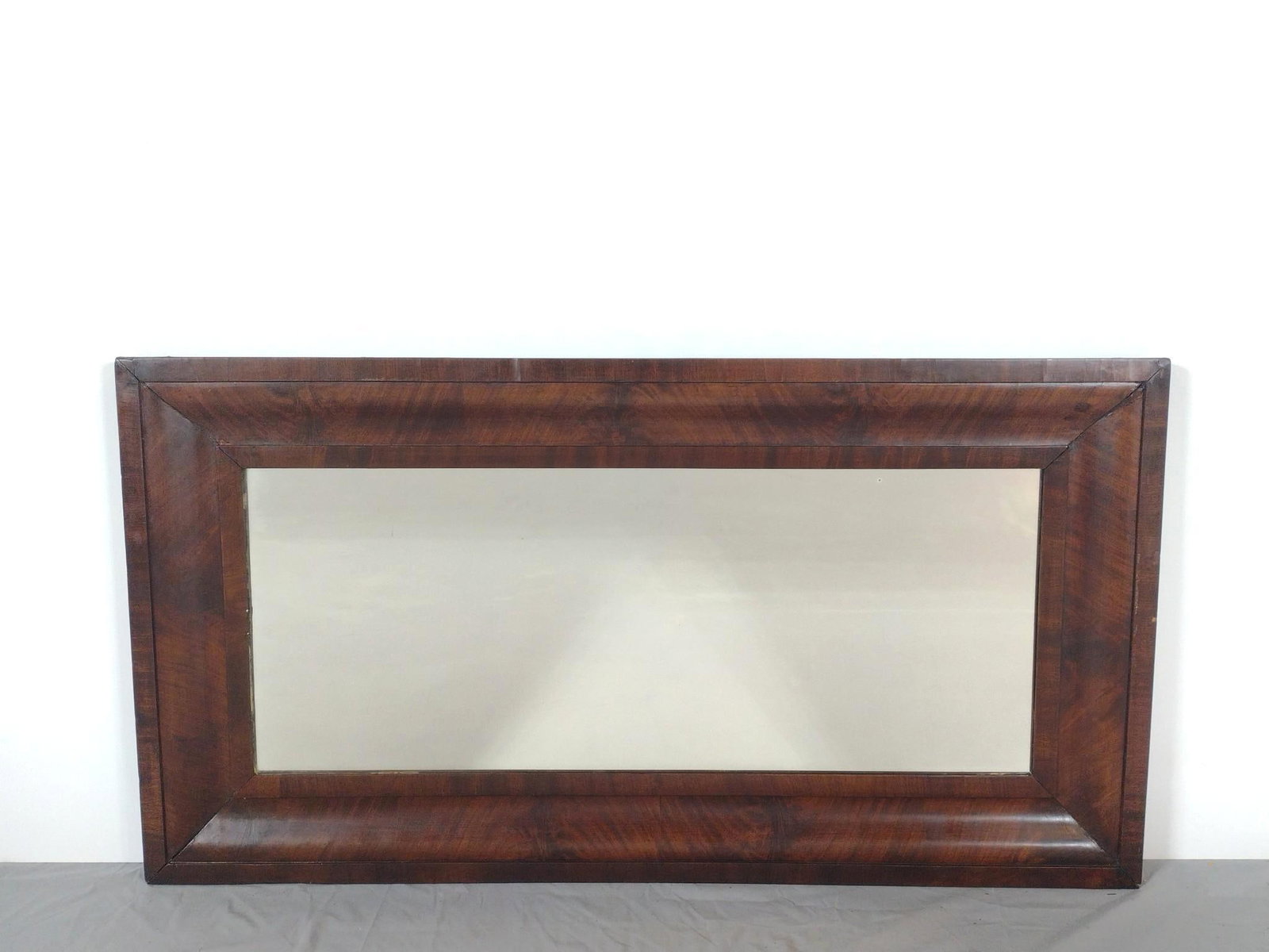 Antique Wood Mirror: NOT ELIGIBLE FOR IN-HOUSE SHIPPING. Overall with frame: 23-1/4" high x 44" wide. Some scratches to frame.