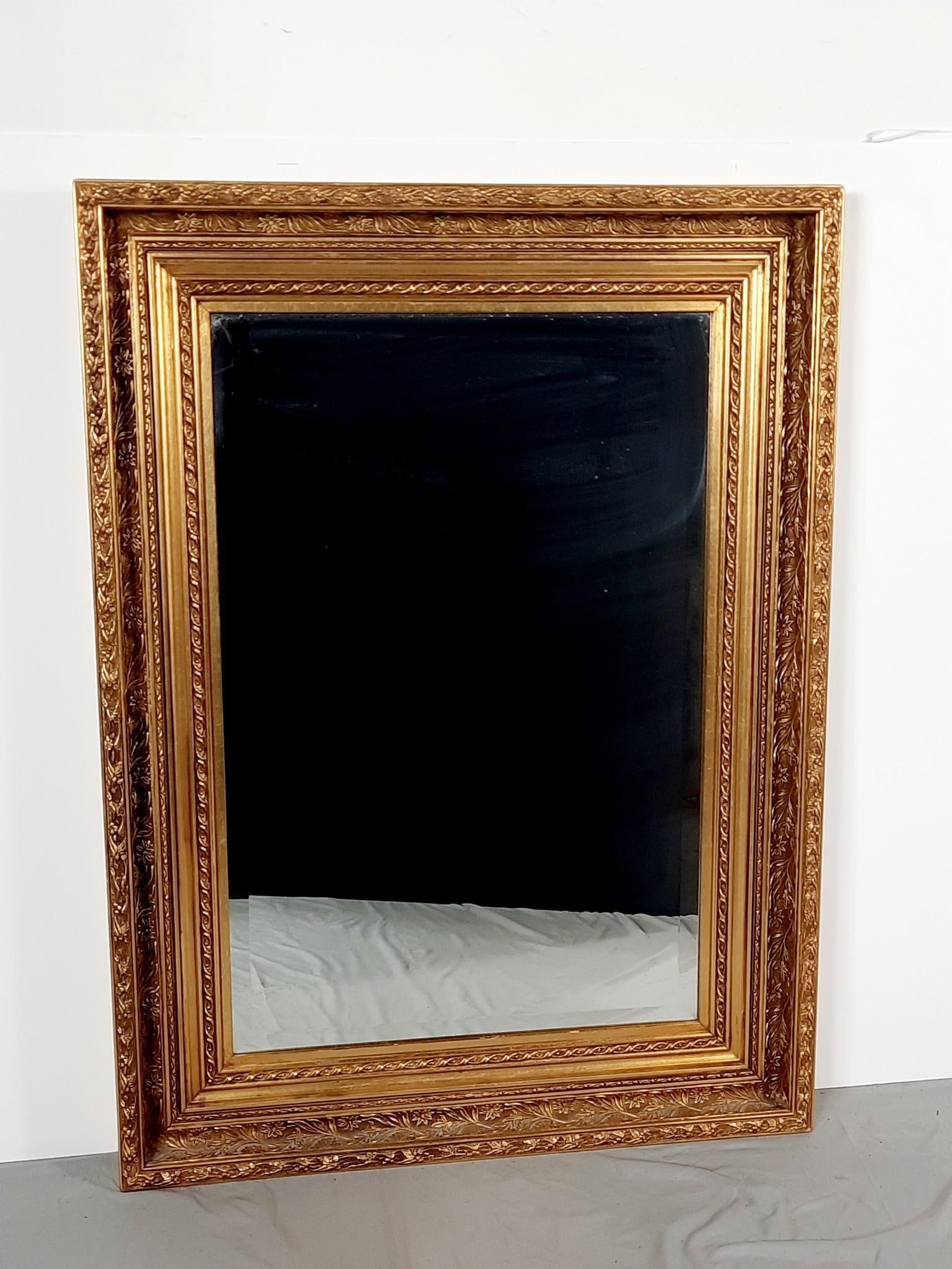 Vintage Gilt Mirror with Floral Motif: NOT ELIGIBLE FOR IN-HOUSE SHIPPING. Beveled glass. Overall with frame: 47" high x 34-1/2" wide.