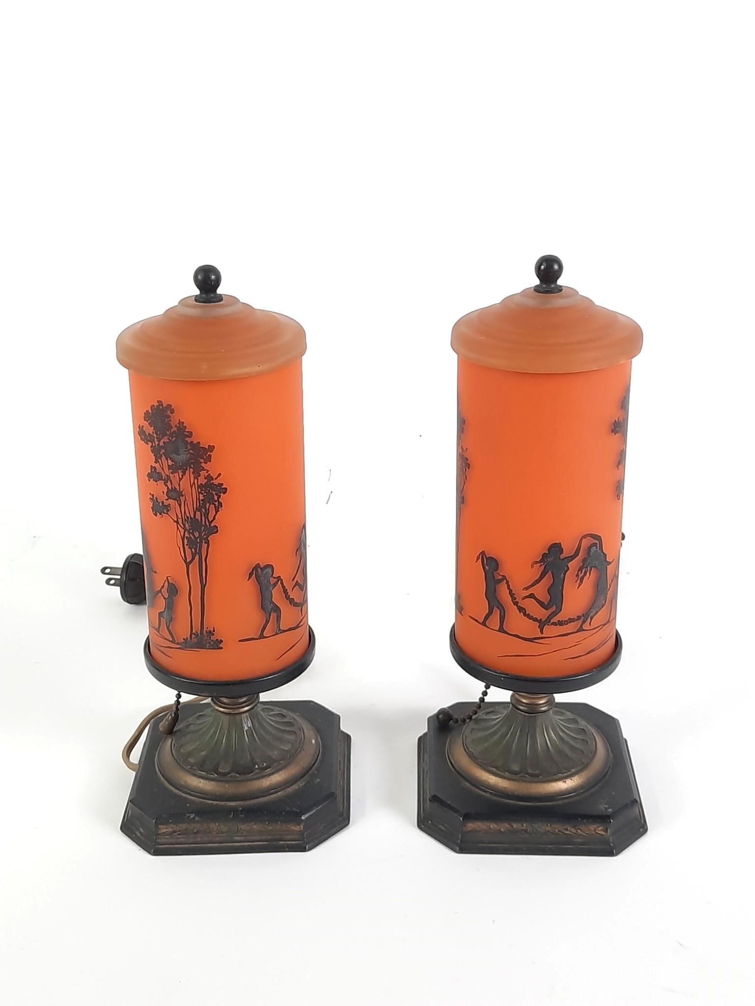 Pair of Silhouette Boudoir Lamps: Art deco lamps featuring silhouettes of figures dancing. Chip to one rim. 10-1/2" high, bases 4-1/2" wide.