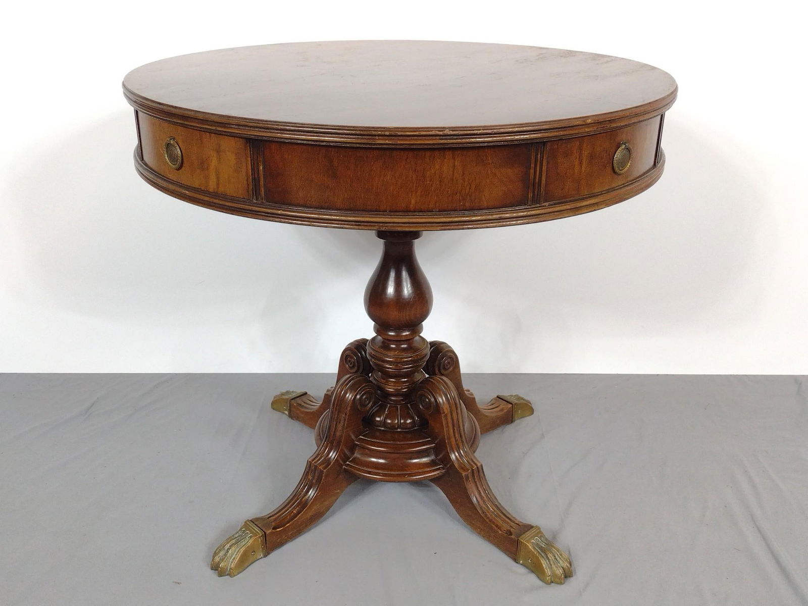 Four Drawer Drum Table: NOT ELIGIBLE FOR IN-HOUSE SHIPPING. 32" diameter X 29" high. Has some scratches. Top also has finish loss.