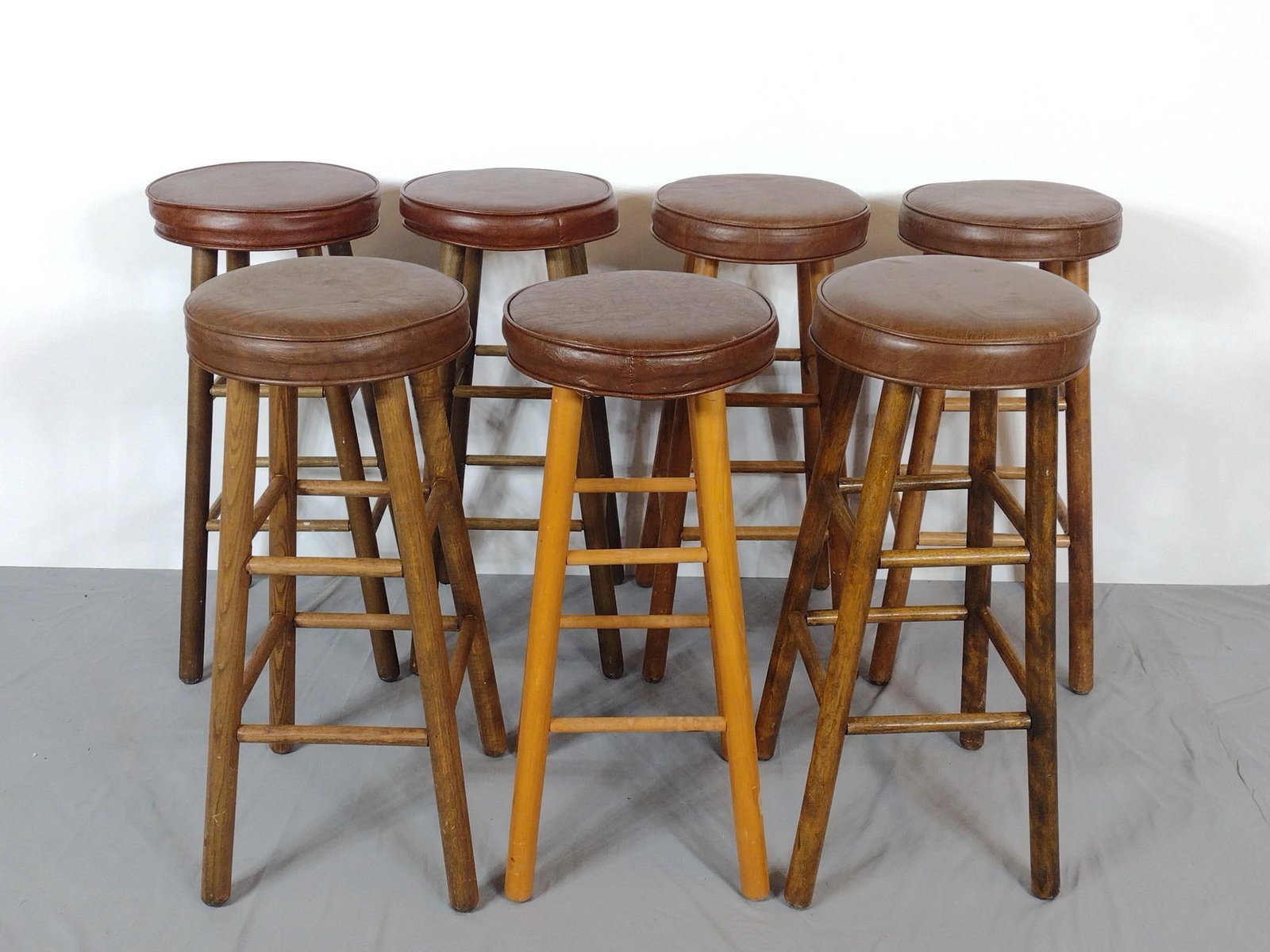 7 Wood Bar Stools: NOT ELIGIBLE FOR IN-HOUSE SHIPPING. 14" wide X 14" deep X 30-1/2" high. All have some scratches to wood base.
