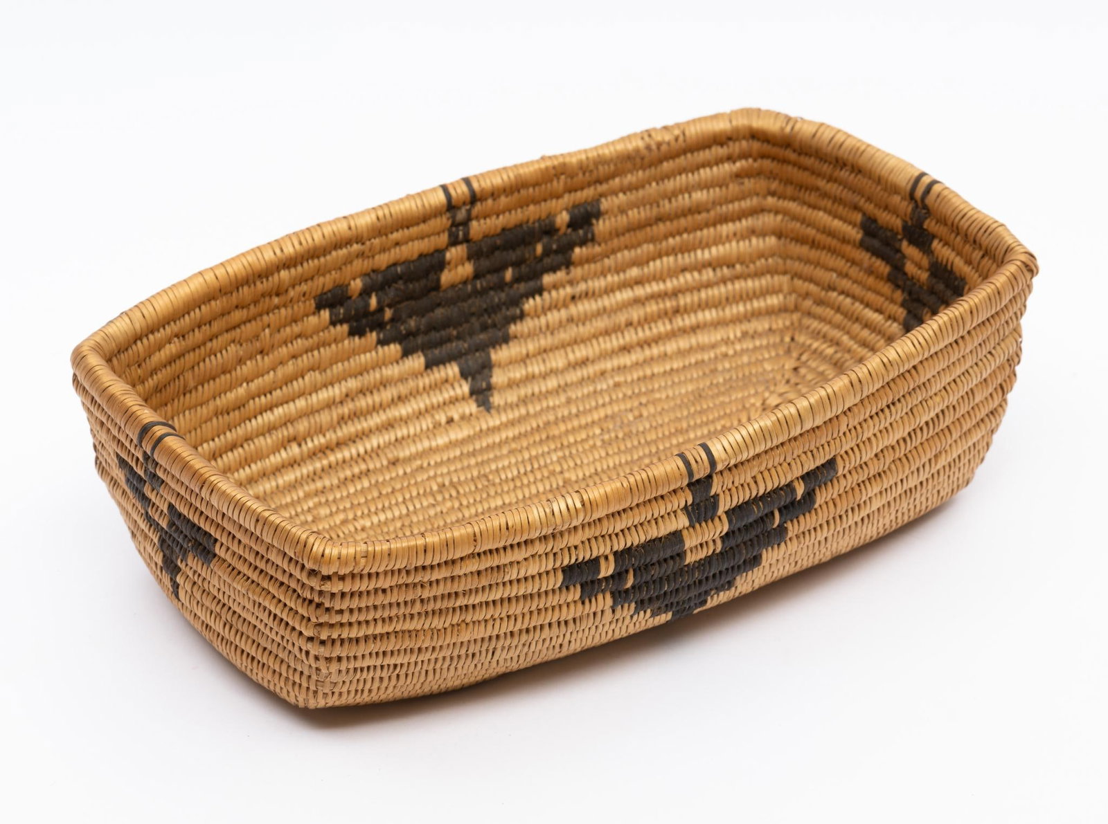 Papago Butterfly Basket: A very fine and tightly woven Pima/Papago long basket probably a letter basket. This example incorporates well executed and tightly woven butterflies along the top edge. Measurements: 5-1/4" x 8-1/2" 