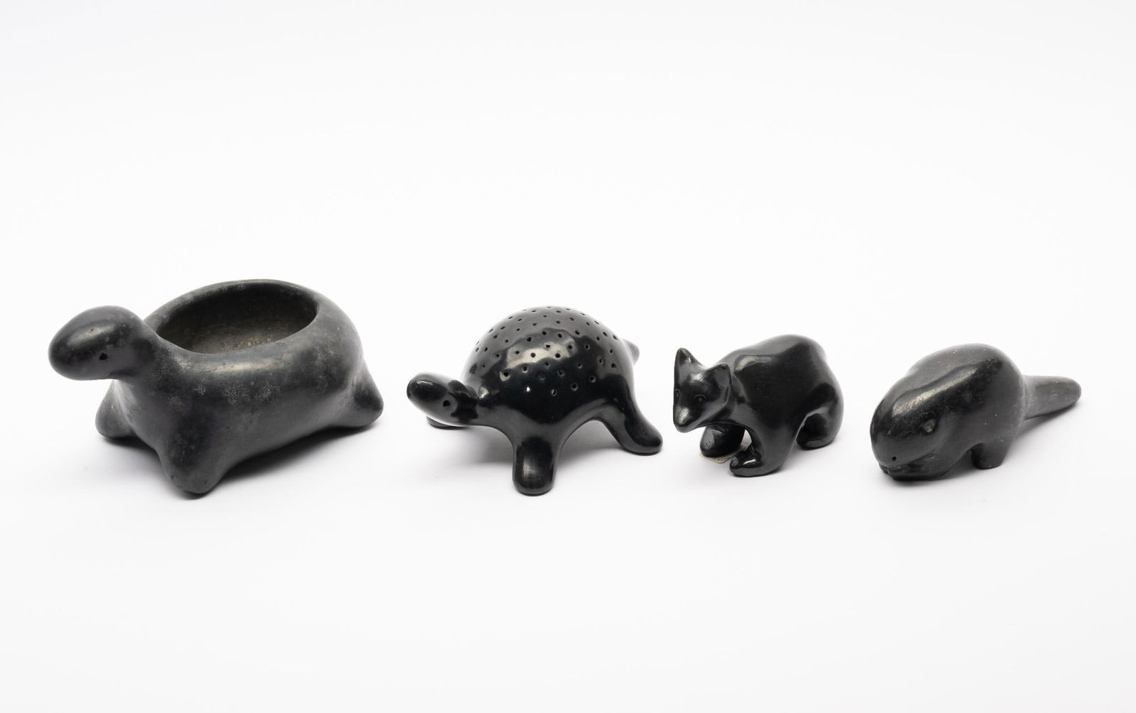 Four Burnished Blackware Animal Table Figures: A group of four blackware table figures of animals probably San Ildefonso and Santa Clara Pueblos. Signed indistinctly on two examples. Mid to late 20th century. Measurement: 3-1/2" to 6" long Conditi
