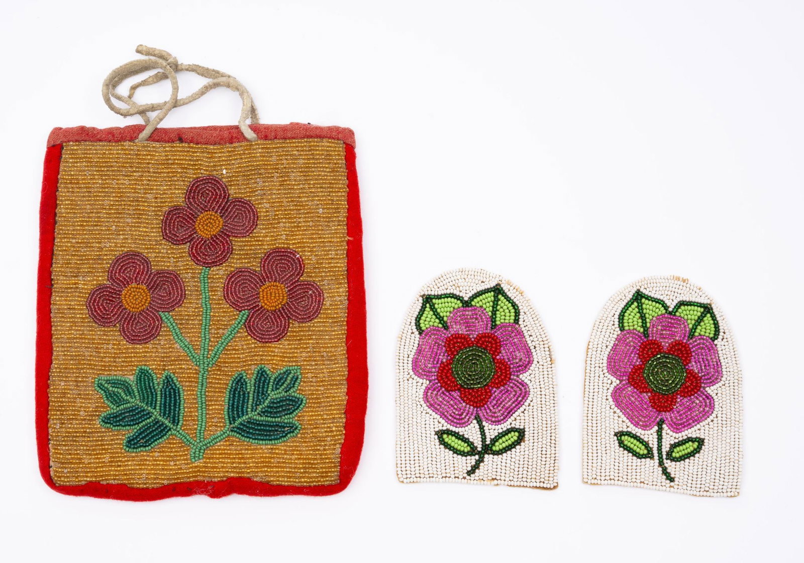 A Plateau Bag and a Pair of Beaded Uppers: A very fine Plateau bag with central flower together with a pair of beaded floral moccasin uppers (probably Athabaskan). Measurements: Bag 7-1/4" to 6-1/2" Patches 3" x 4-1/2" Condition: Overall good 