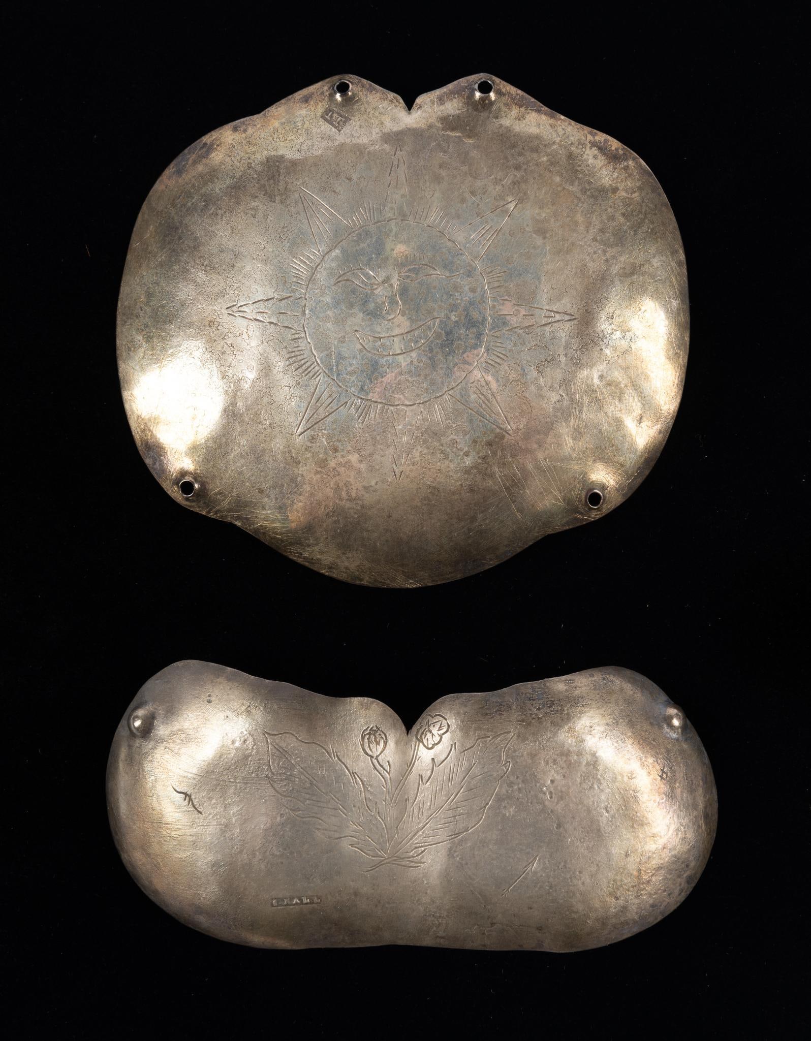 2 Gorget Form Indian Trade Silver Pieces: Two silver gorget form (with loops for stitching to clothing or hanging from ribbons on the edges) trade silver pieces. The first engraved with a sun face and marked IT probably for John Thomson (?-17