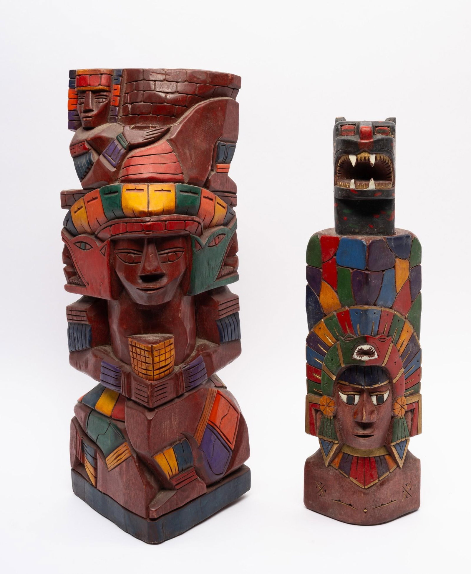 2 Polychrome Pacific Northwest Tribal Totem Poles: Two carved polychrome Pacific Northwest tribal totem poles probably second half of the 20th century. Measurements: 16" to 17-1/2" tall. Condition: Overall good.
