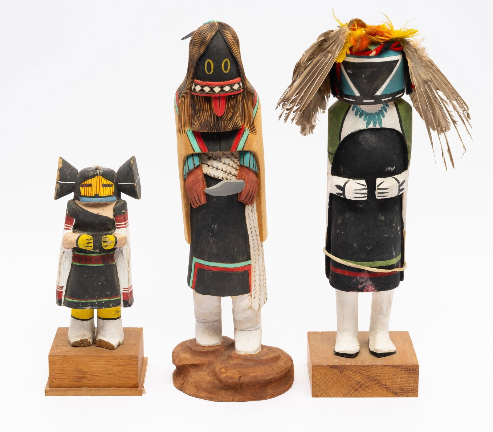 3 Hopi Katsinas or Kachinas: Three articulated katsina figures. The first an unsigned Mother katsina. The second of Ogrewoman signed Clifford Charley. The third titled Morning Earth Mother but not signed. Measurements: 9" to 14" 