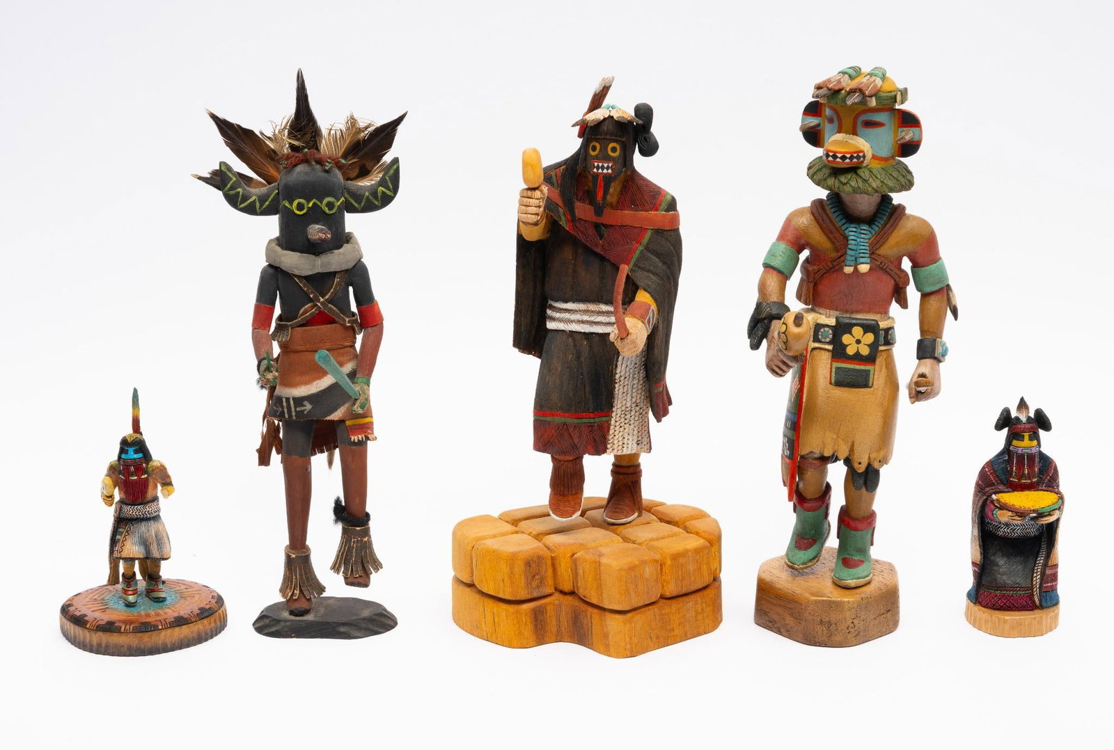 5 Carved Wooden Hopi Katsinas or Kachinas: A group of five carved Hopi Katsinas. The first, Angak or Long Hair, carved by "Sterling McRae." The second, Nataska or Black Ogre, unsigned. The third, an Orgre, signed "Earl Talayumptewa." The fourt