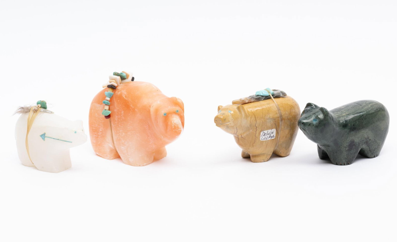4 Carved Stone Bear Fetishes by Various Zuni and Pueblo Makers: Four carved stone bear fetishes (one singed Devin Leekah) Zuni and other pueblos, fourth quarter of the 20th century. Measurements: 2-3/4" to 3-3/4" long. Condition: Overall good.