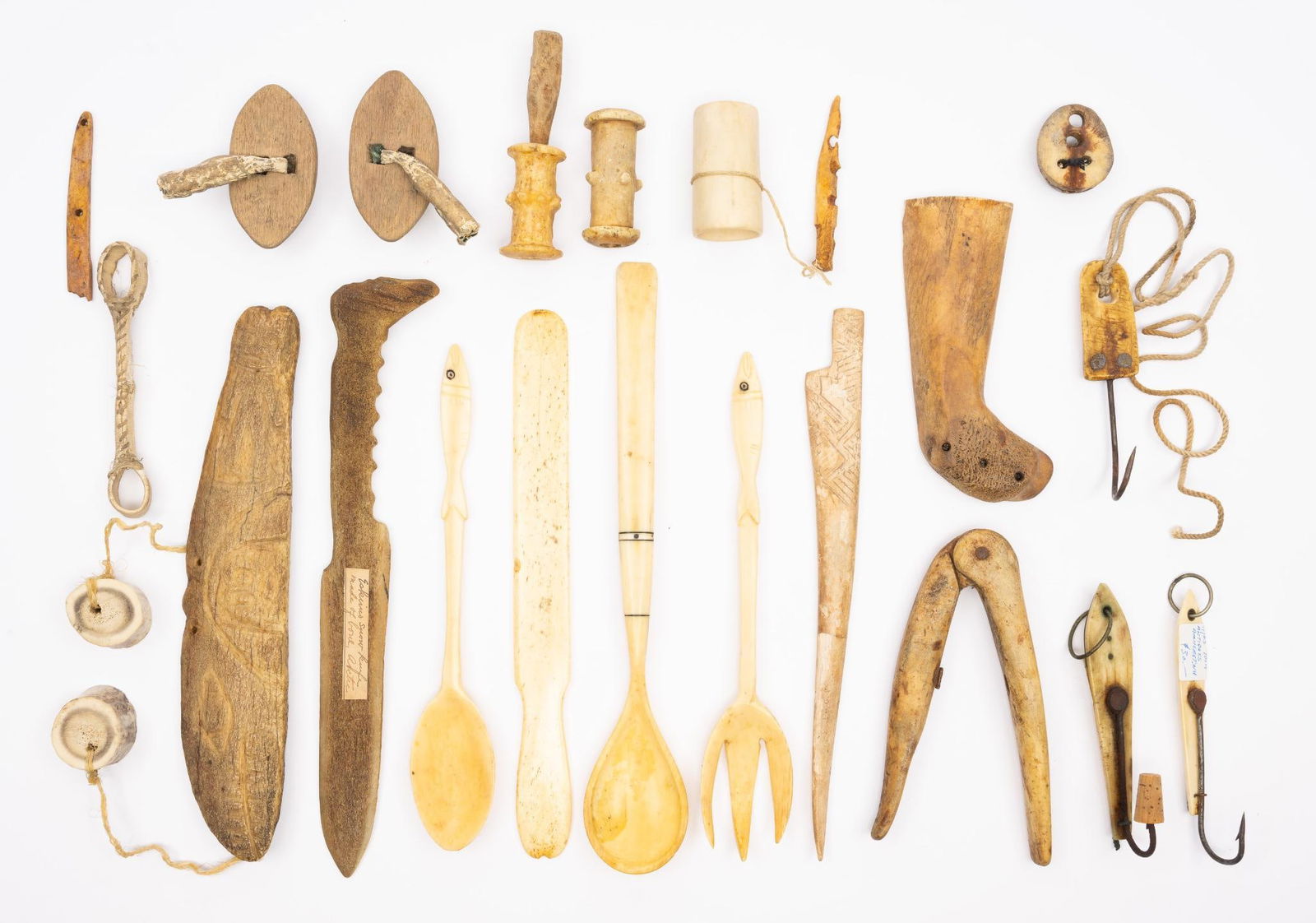 Twenty Bone and Metal Eskimo Tools: A collection of bone and metal worked tools attributed based on old labels to Eskimo people. Items include fishing lures, knives, drills and other tools. Measurement: 1-1/2" to 11". Condition: Overall