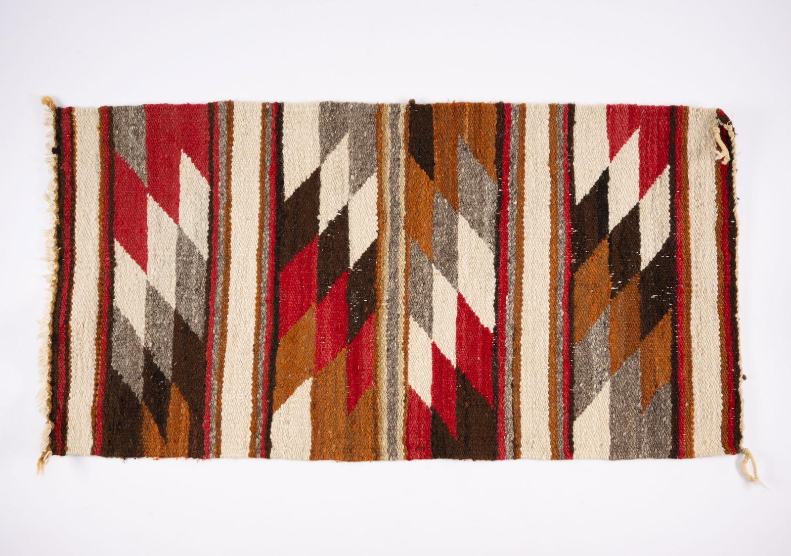 Navajo Saddle Blanket: A lovely Navajo saddle blanket probably third quarter of the 20th century. Measurements: 35" x 18". Condition: Due to being in storage for a number of years, these textiles may have been exposed to mo