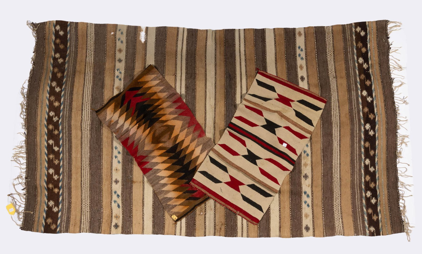 3 Navajo Weavings: Three Navajo weavings including a damaged Crystal Rug and two small eye dazzlers. Measurements: Runners 37" x 19". Rug 94" x 52-1/2". Condition: Due to being in storage for a number of years, these te